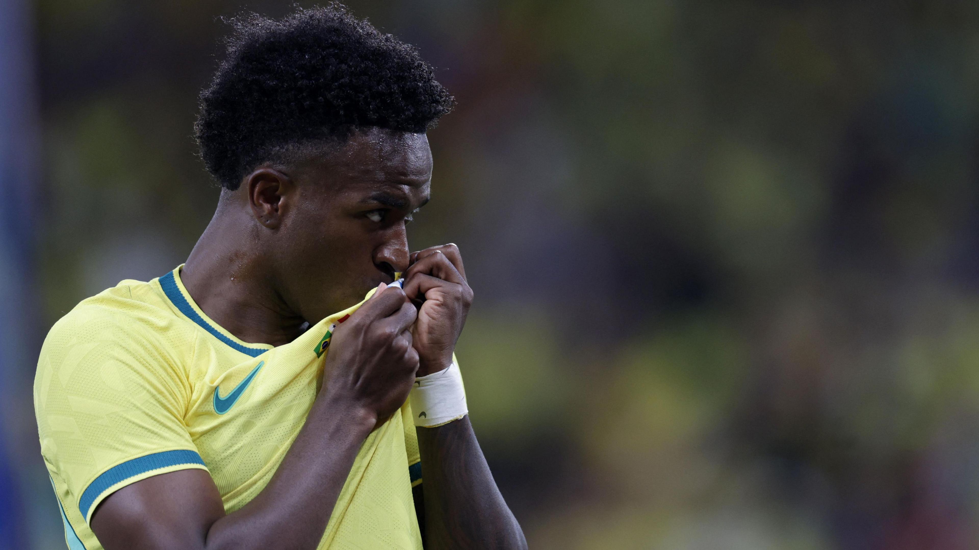 Vinicius Junior kissing the Brazil badge on his shirt
