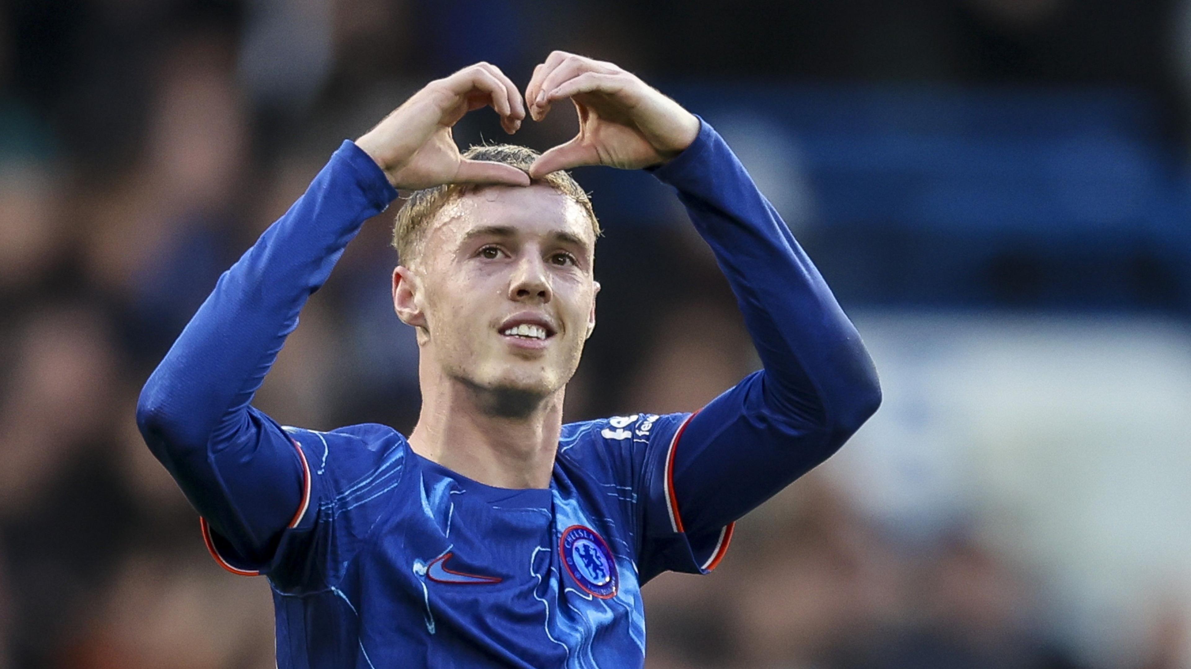 Cole Palmer celebrates a goal by making a heart shape with his hands