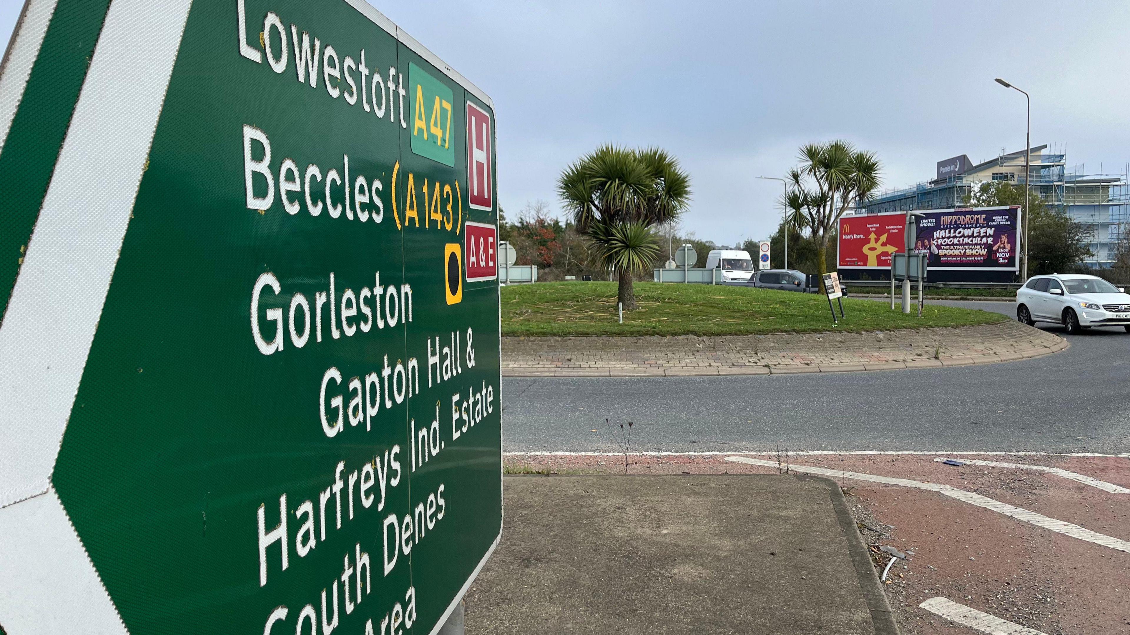 A view of the Vauxhall roundabout. In the foreground there is a road sign pointing to Lowestoft, Beccles, Gorleston, Gapton and Harfrey's Industrial Estate and South Denes.