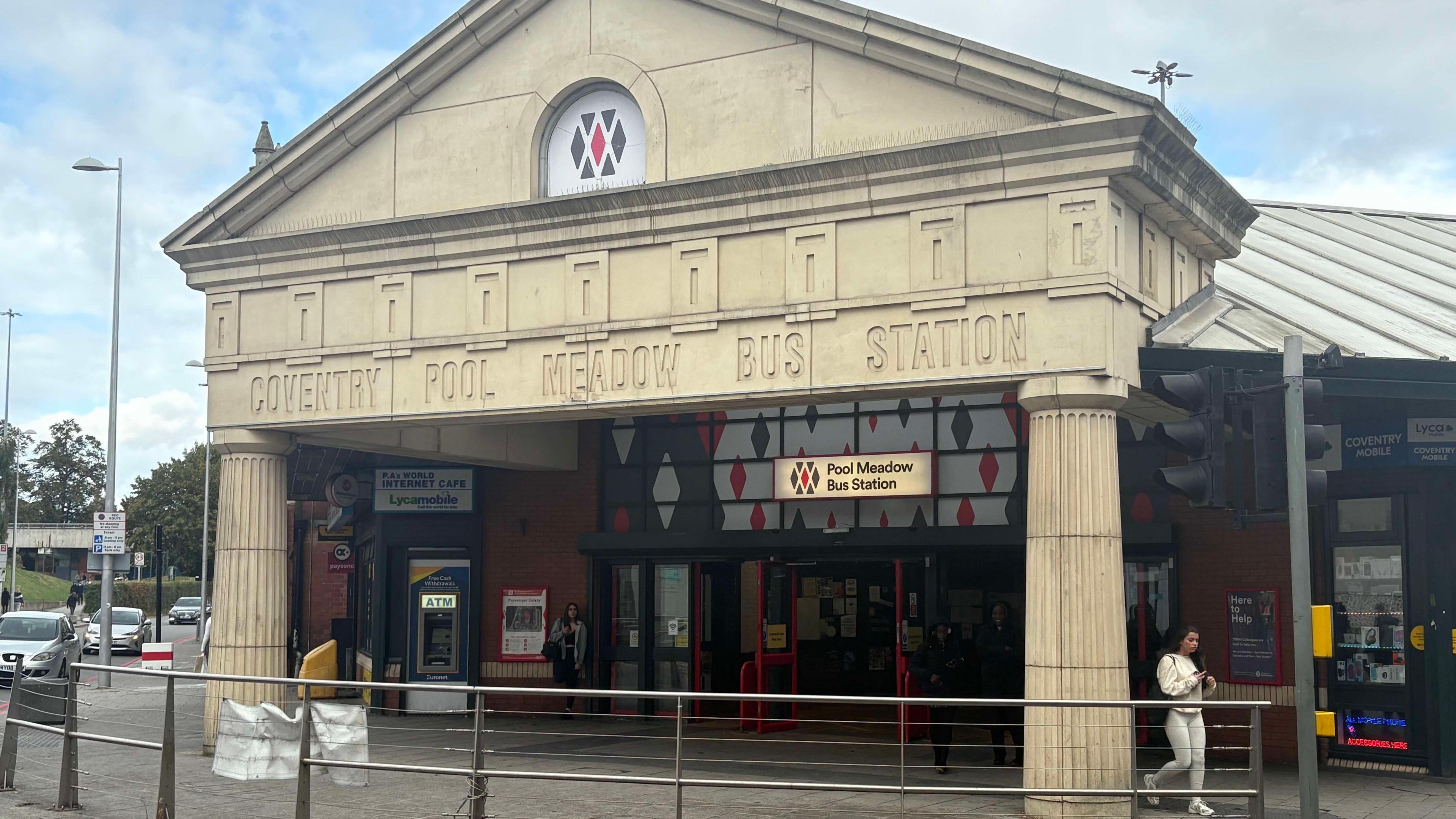 The entrance to Coventry's Pool Meadow Bus Station with pillars on either side of the front door 