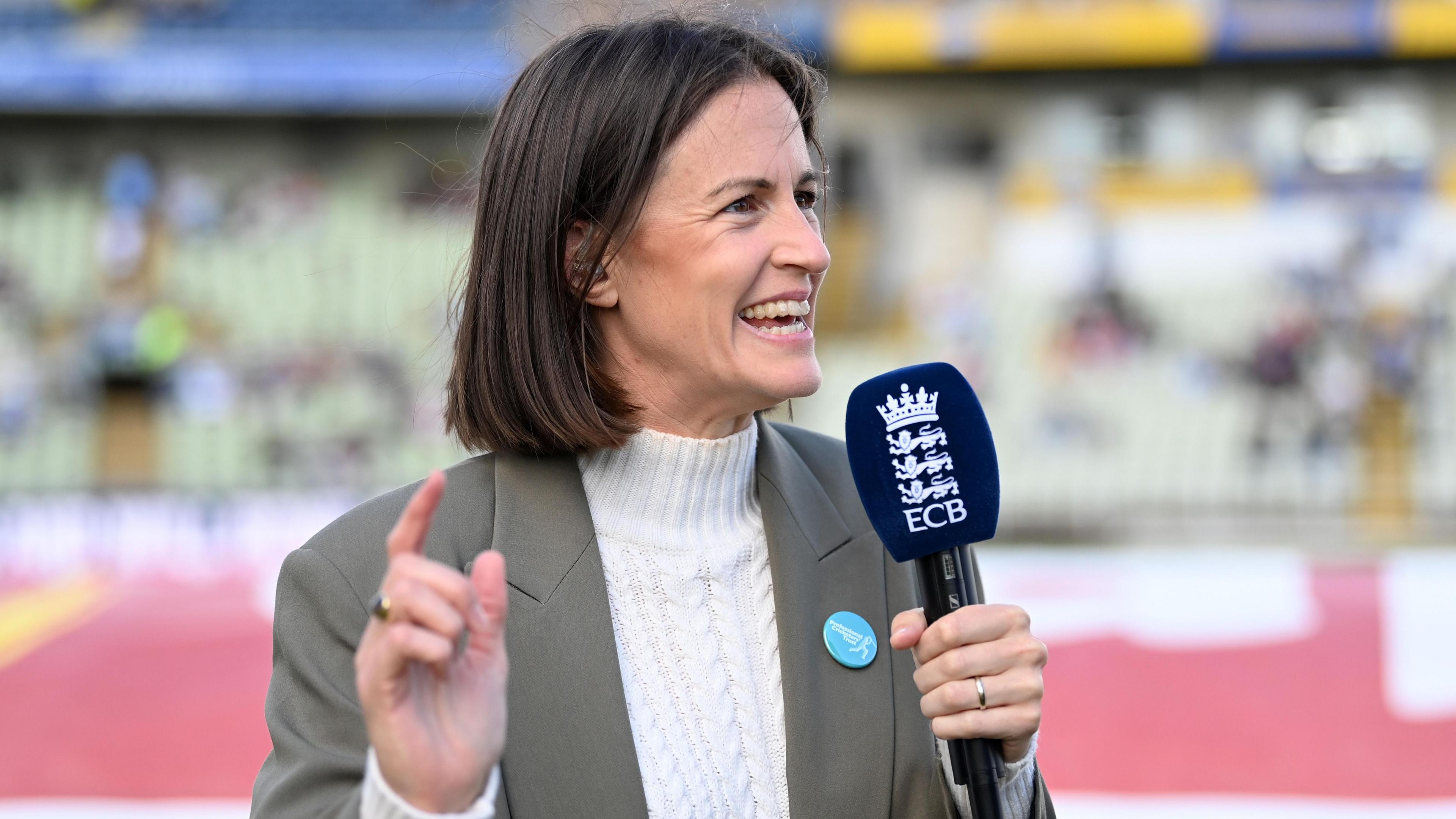 Lydia Greenway holding a microphone