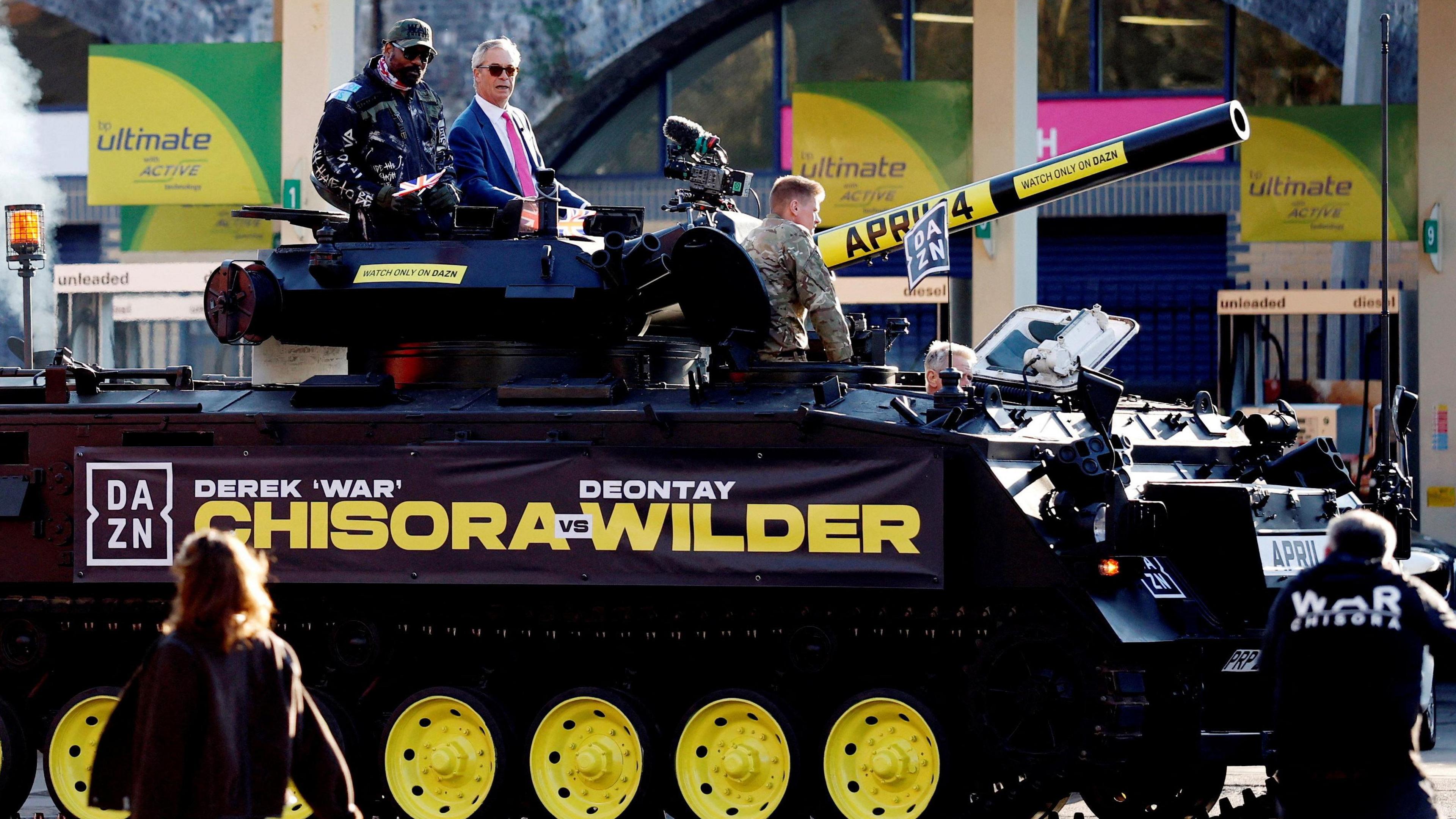 Derek Chisora and Nigel Farage on a tank