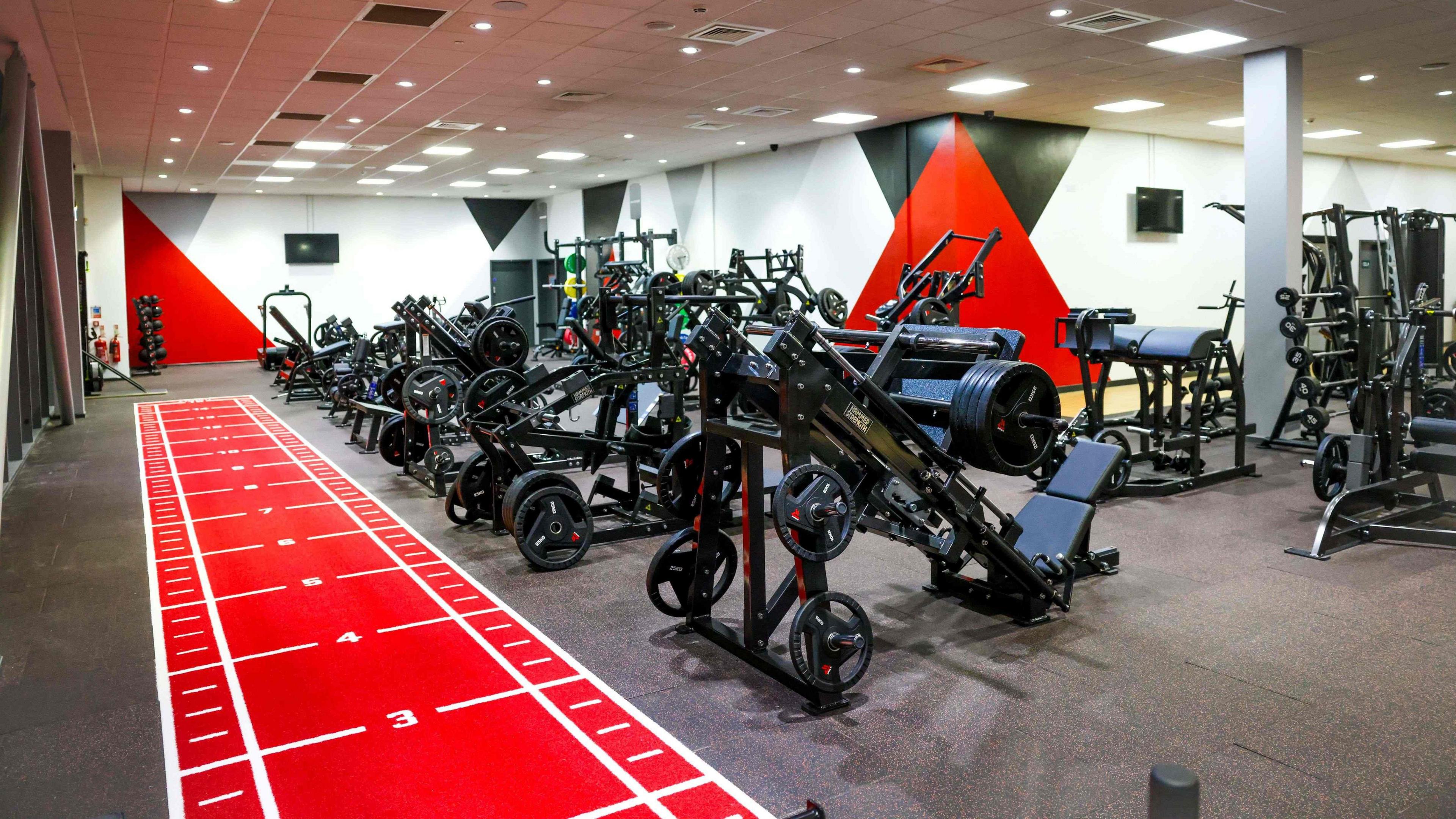 The ground-floor gym at the EISS, featuring new equipment and a red sprint track.
