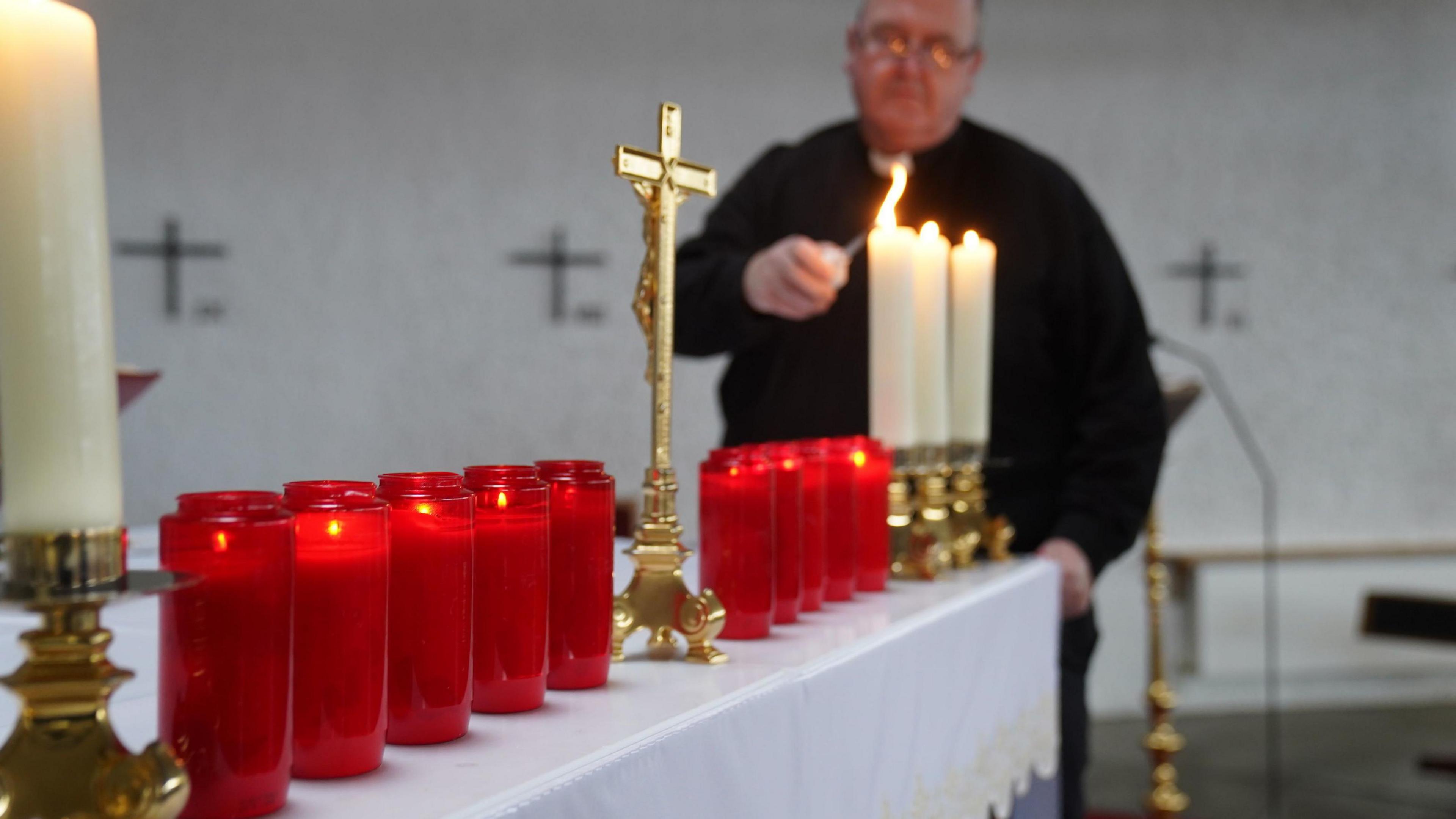 Fr John Joe Duffy lights candles for each of the Creeslough victims