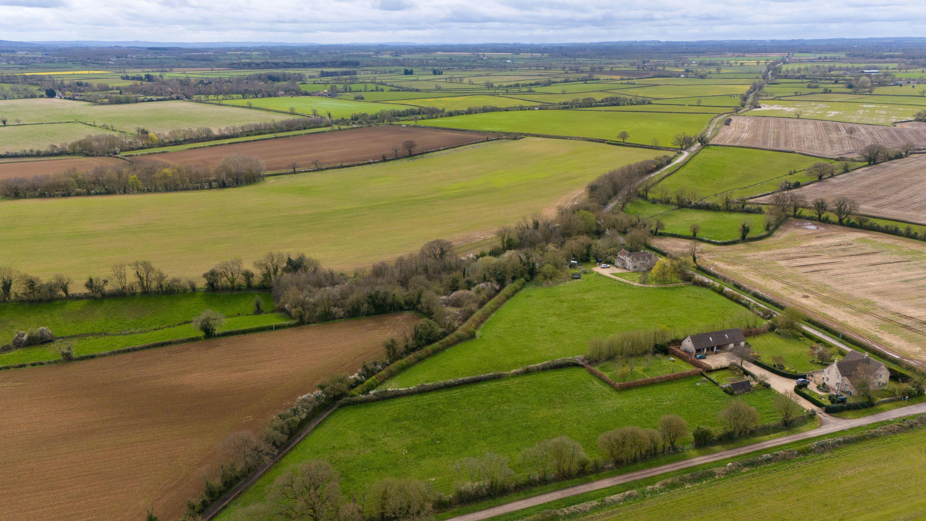 An aerial view of the proposed Lime Down Solar Farm site in Malmesbury, Wiltshire. There are numerous fields spanning for miles, many of them lined with hedgerows