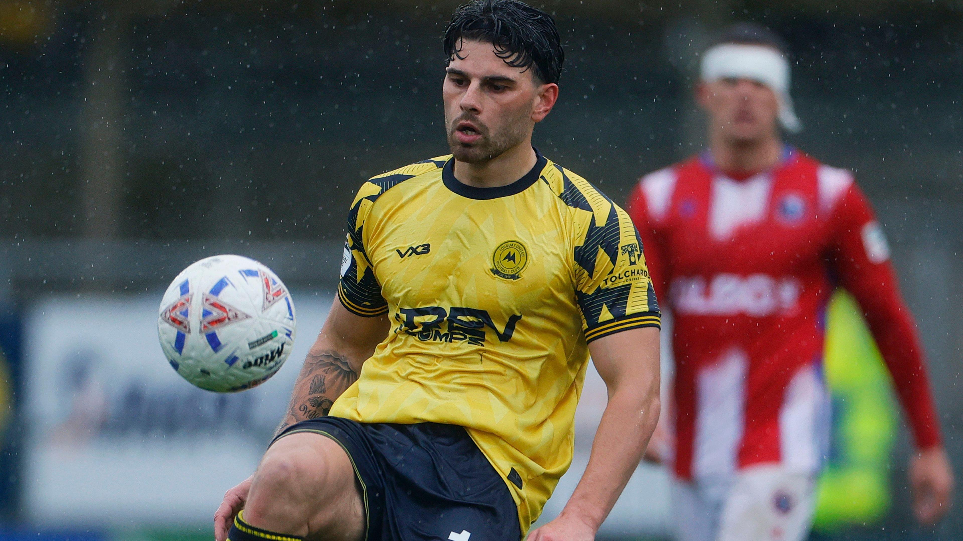 Callum Dolan juggles the ball on his right knee in a match for Torquay United