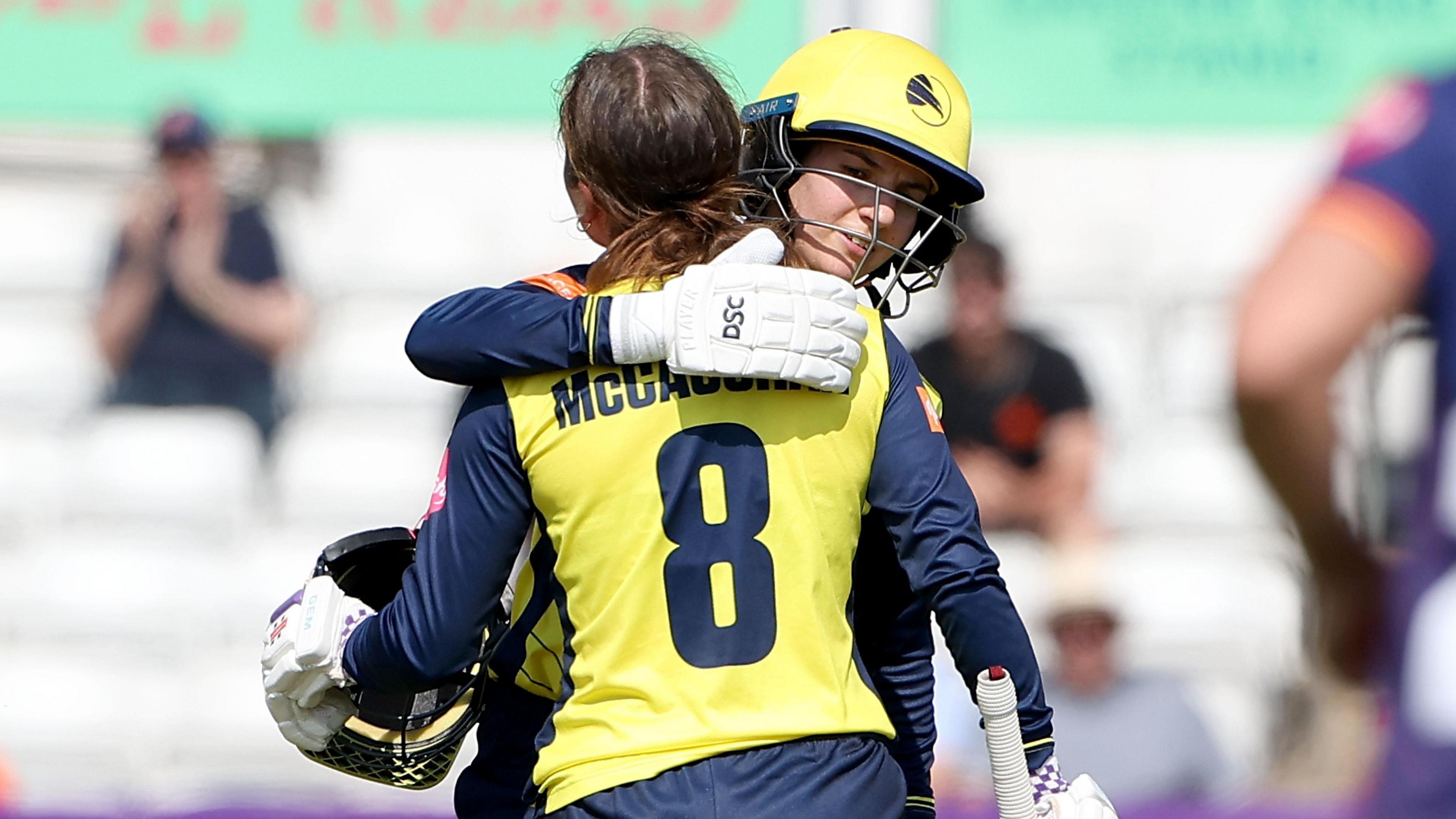 Ella McCaughan and Charli Knott embrace