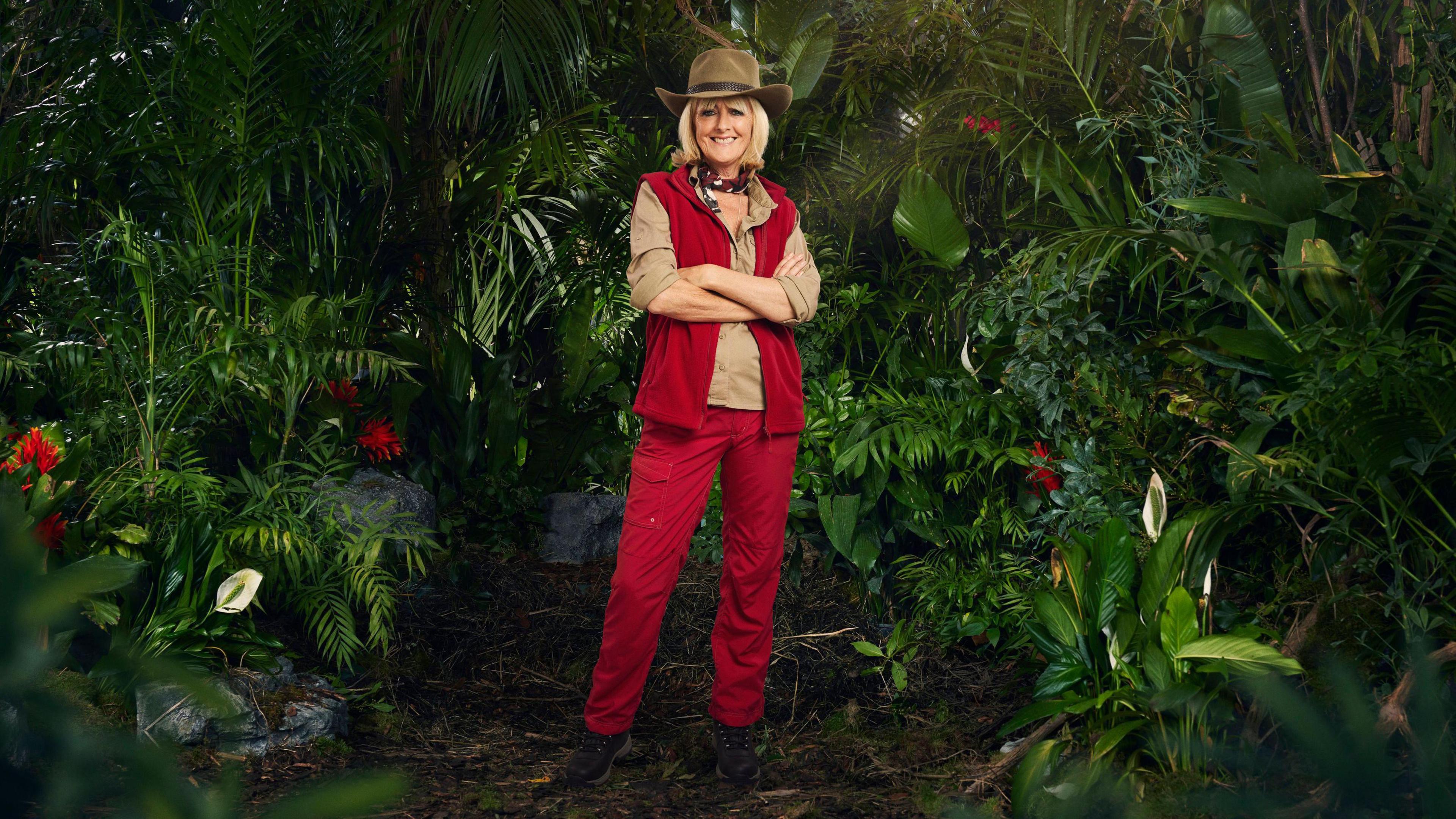  Jane Moore in her jungle outfit surrounded by plants 