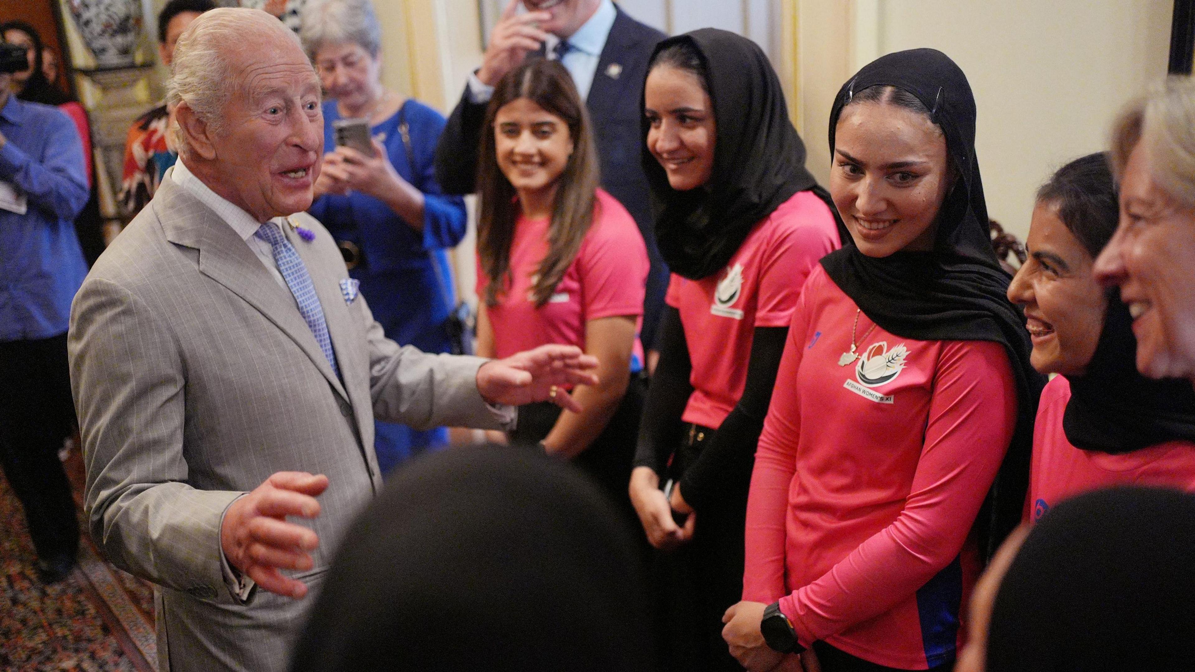 King Charles speaks to members of Afghanistan women's cricket team at a reception