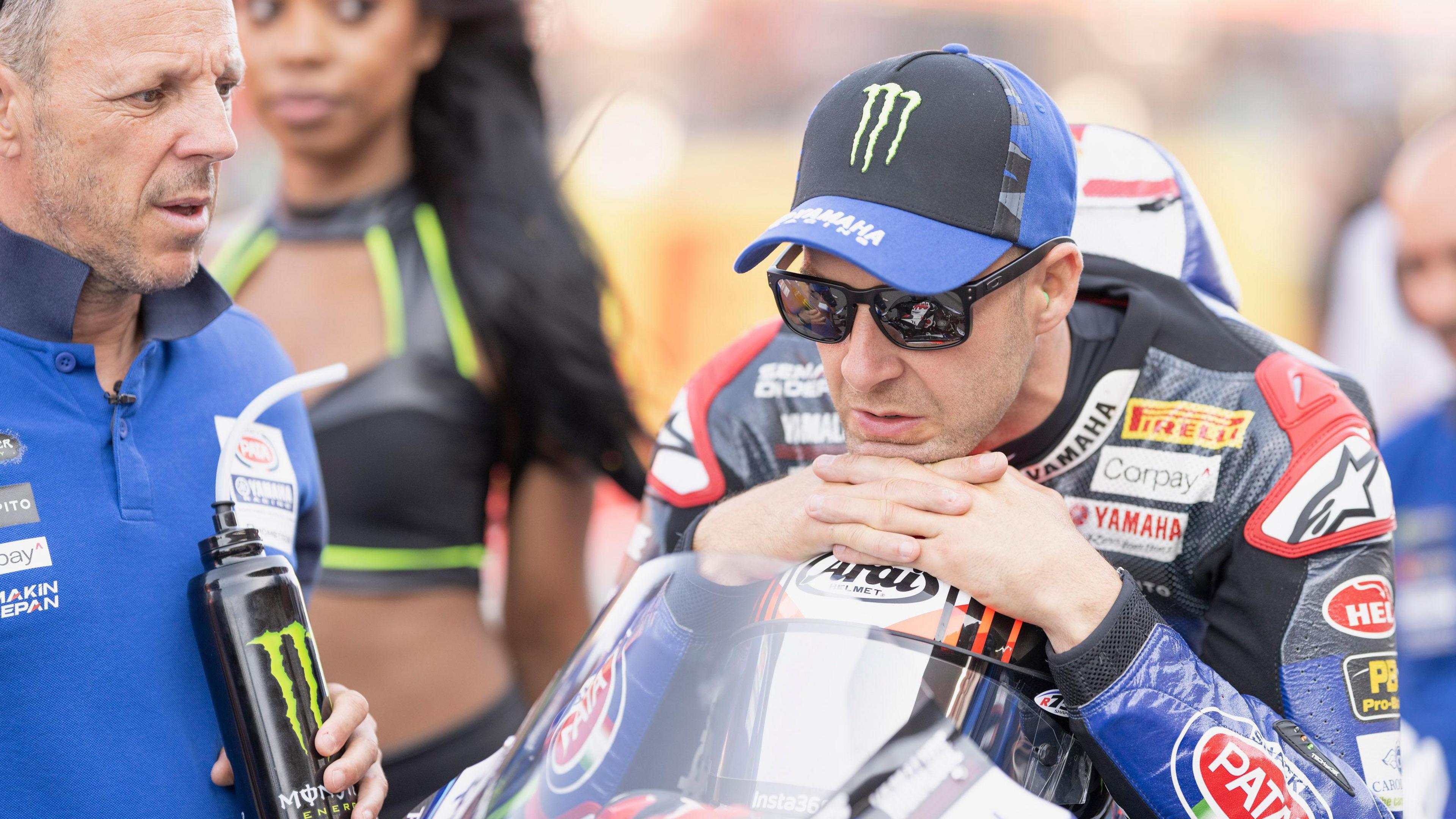 Jonathan Rea perches on his bike in a baseball cap