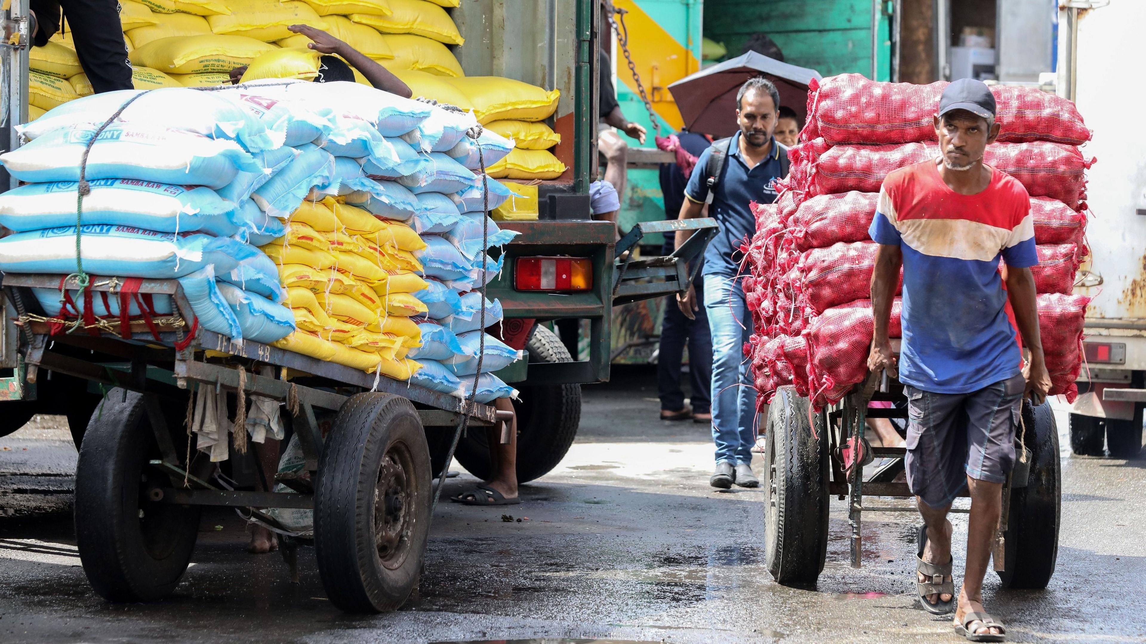 Hand cart pullers work at a wholesale market in the commercial hub of Colombo, Sri Lanka, 13 September 2024. 