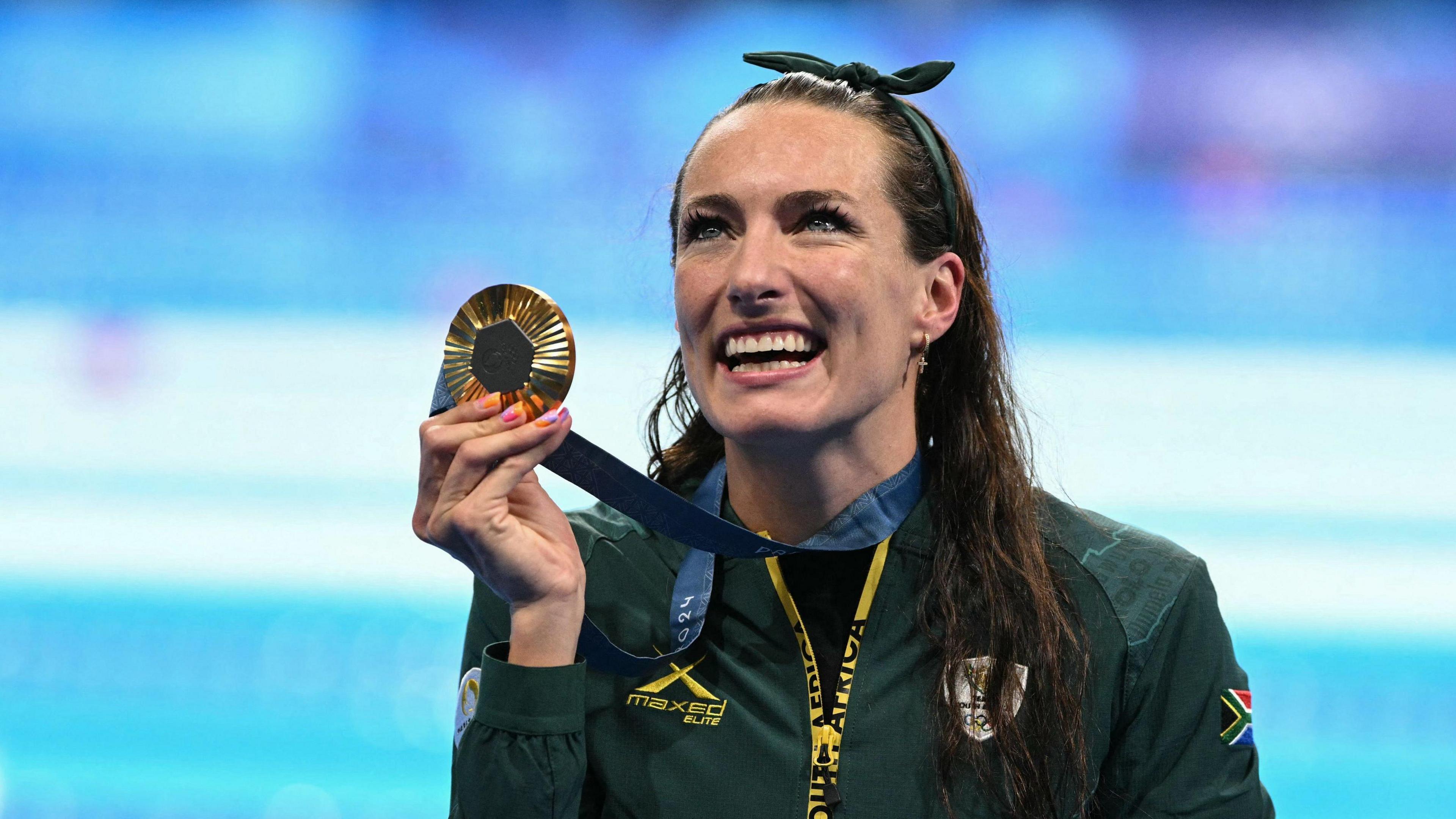 Gold medallist South Africa's Tatjana Smith poses with her medal after the women's 100m breaststroke final at Paris 2024