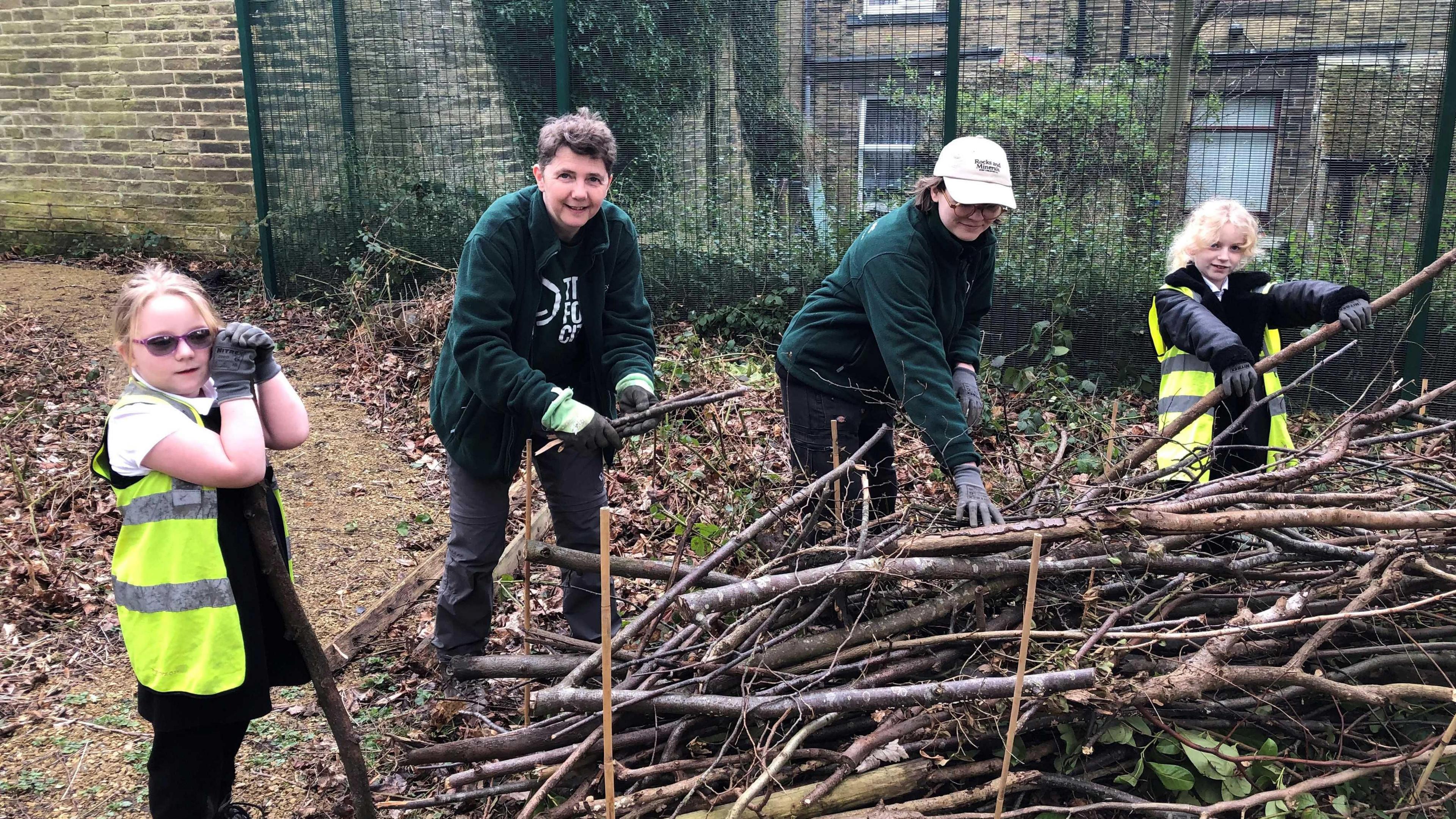 Lana, Elly, Mel and Rachel making a wall from twigs