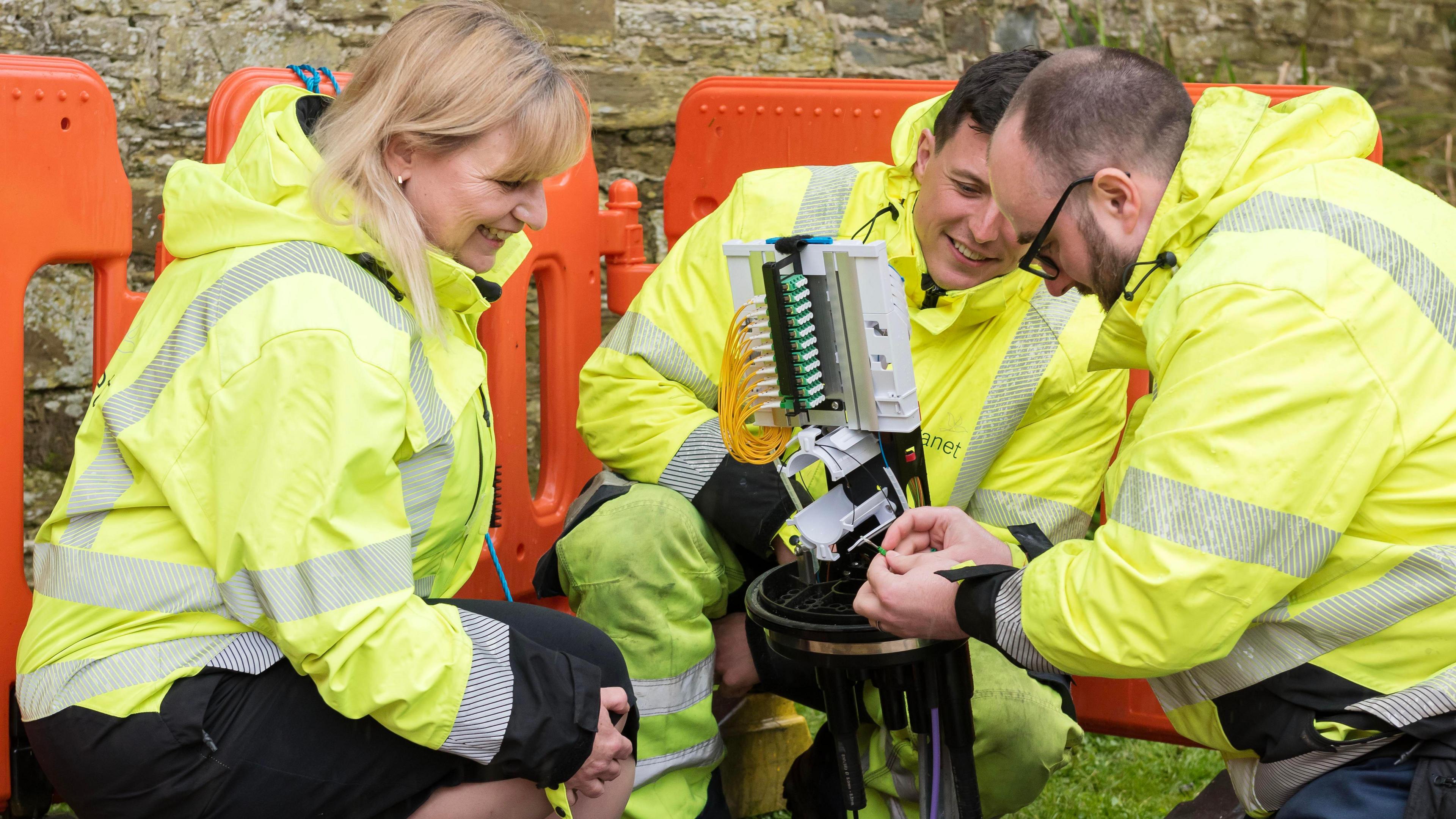 Wildanet chief executive officer Helen Wylde-Archibald with two people working on an installation