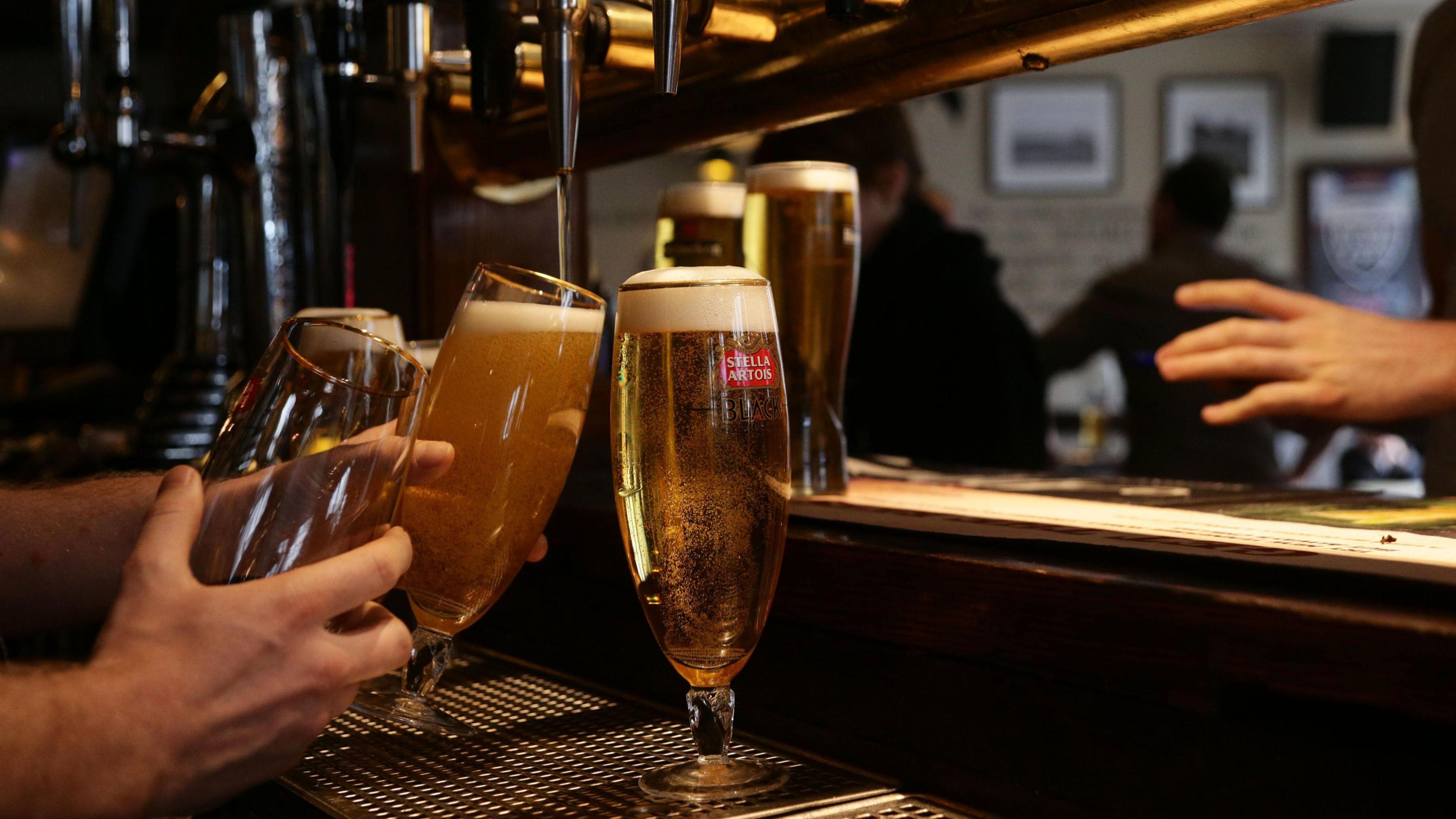 Drinks being poured at a pub