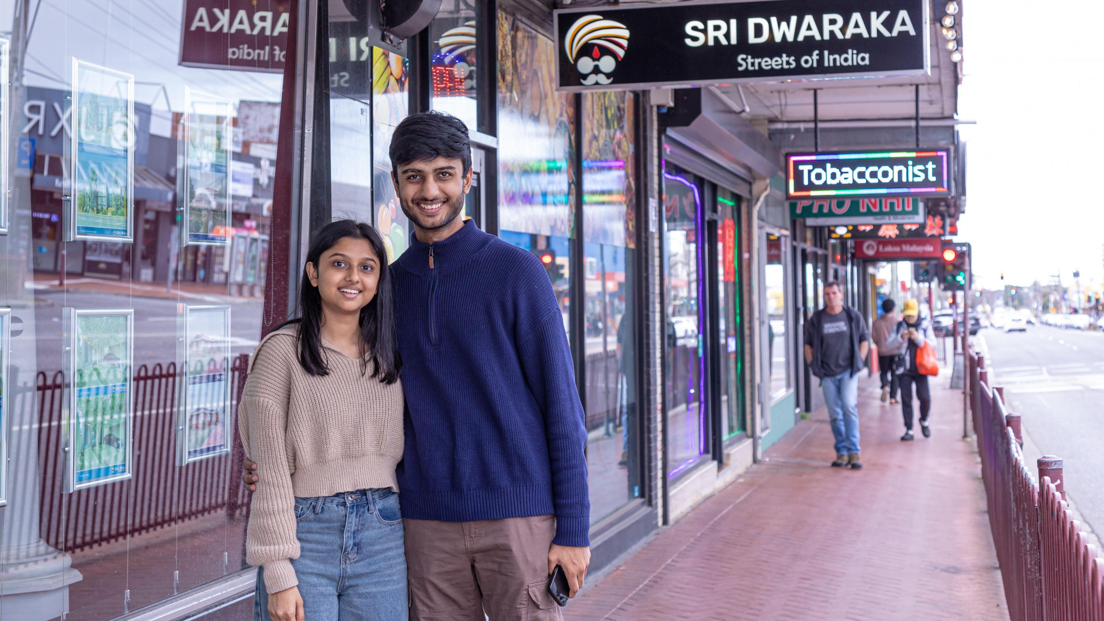 Vedant Gadhavi and his girlfriend Ayushi pose for a photo outside an Indian restaurant in Melbourne