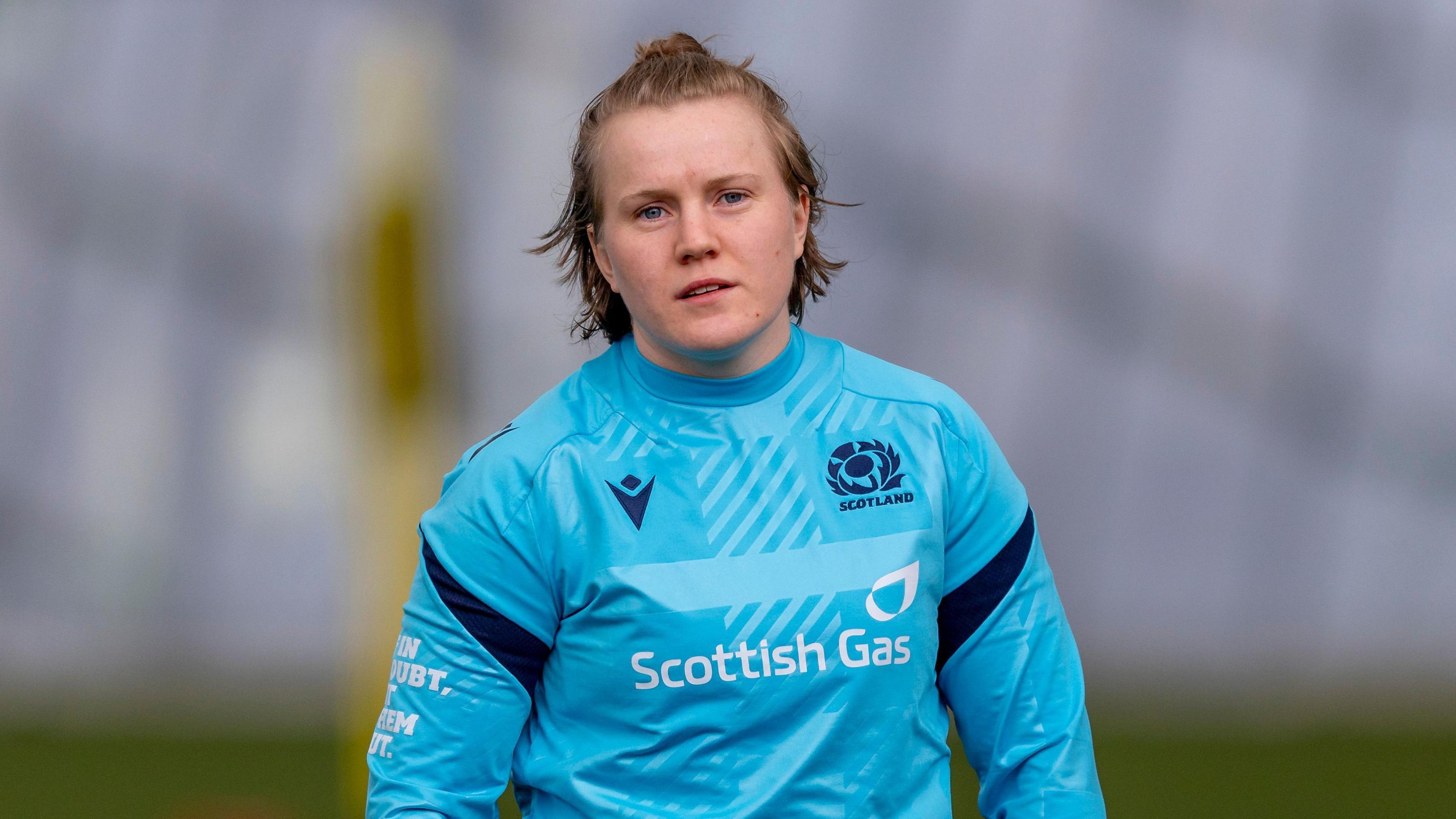Meryl Smith standing on a pitch during a training session for Scotland