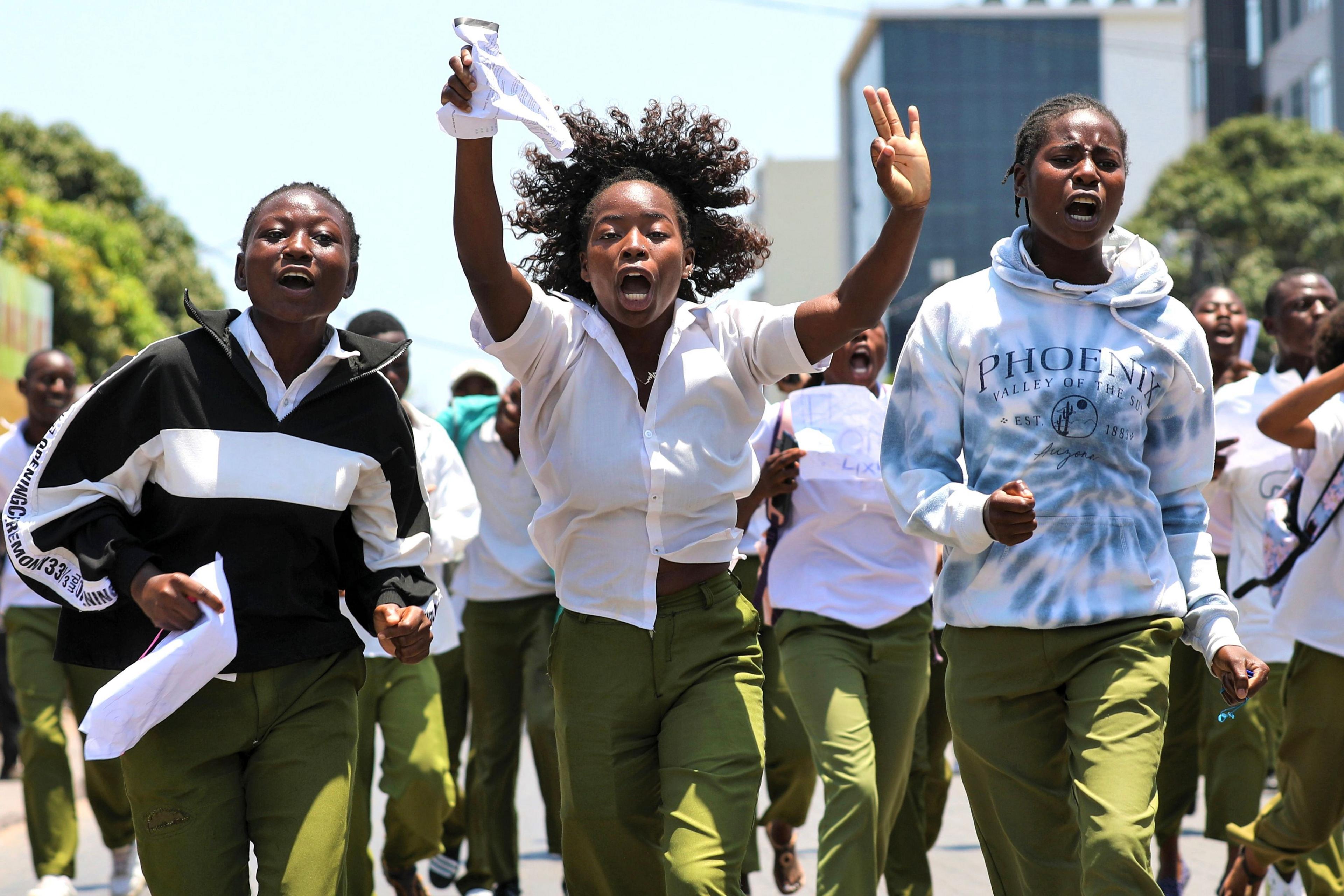 Teenagers in school uniform jog and chant.