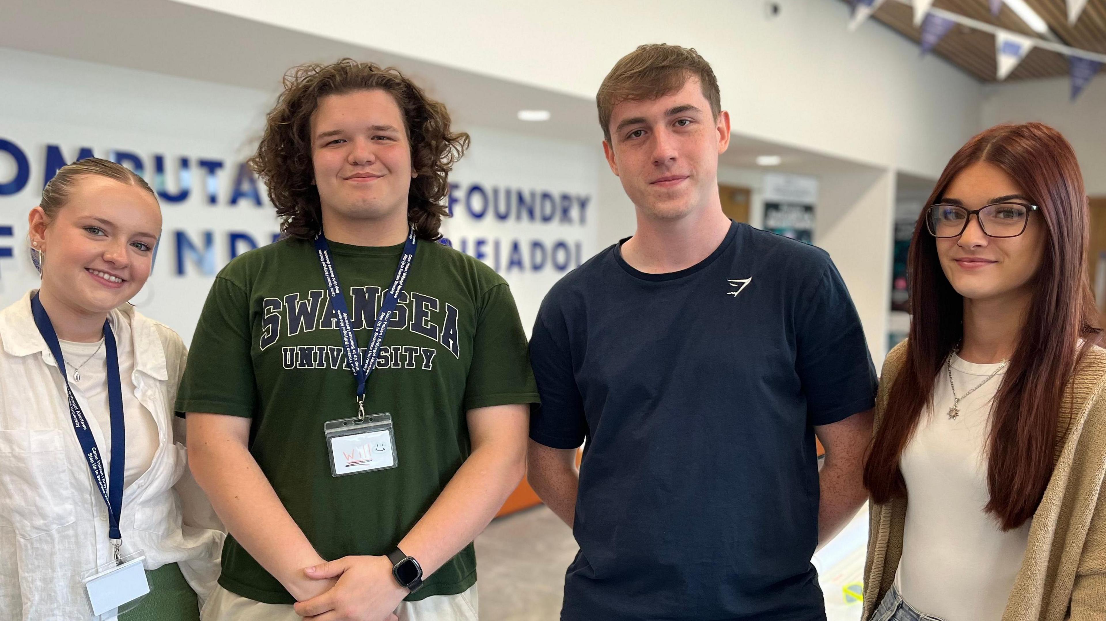 Four students smiling at the camera