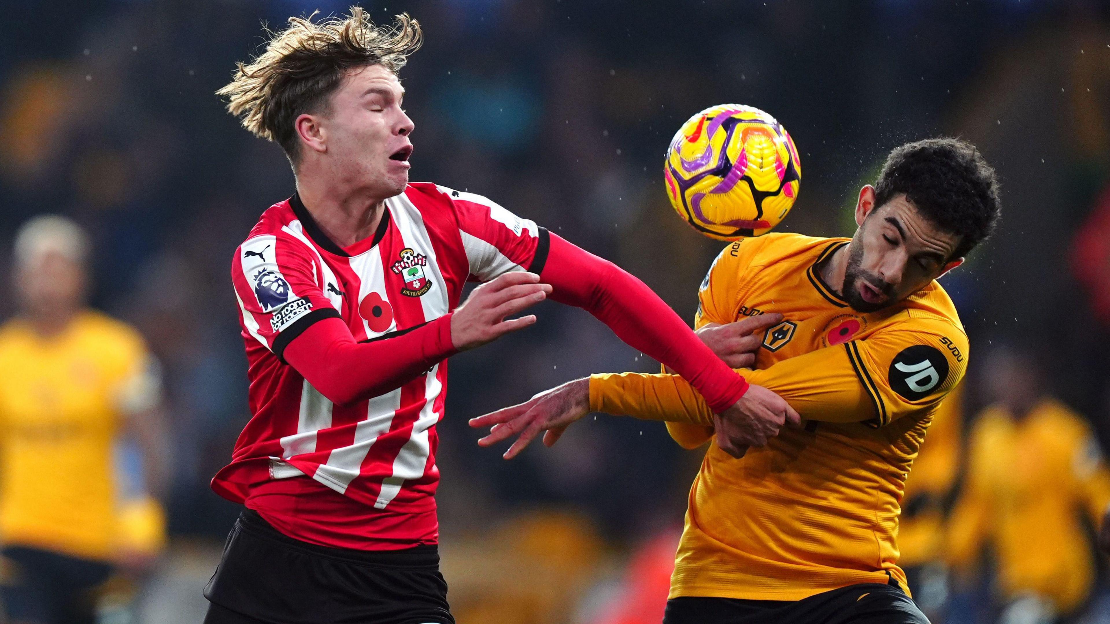 Tyler Dibling and Rayan Ait-Nouri battle for the ball 