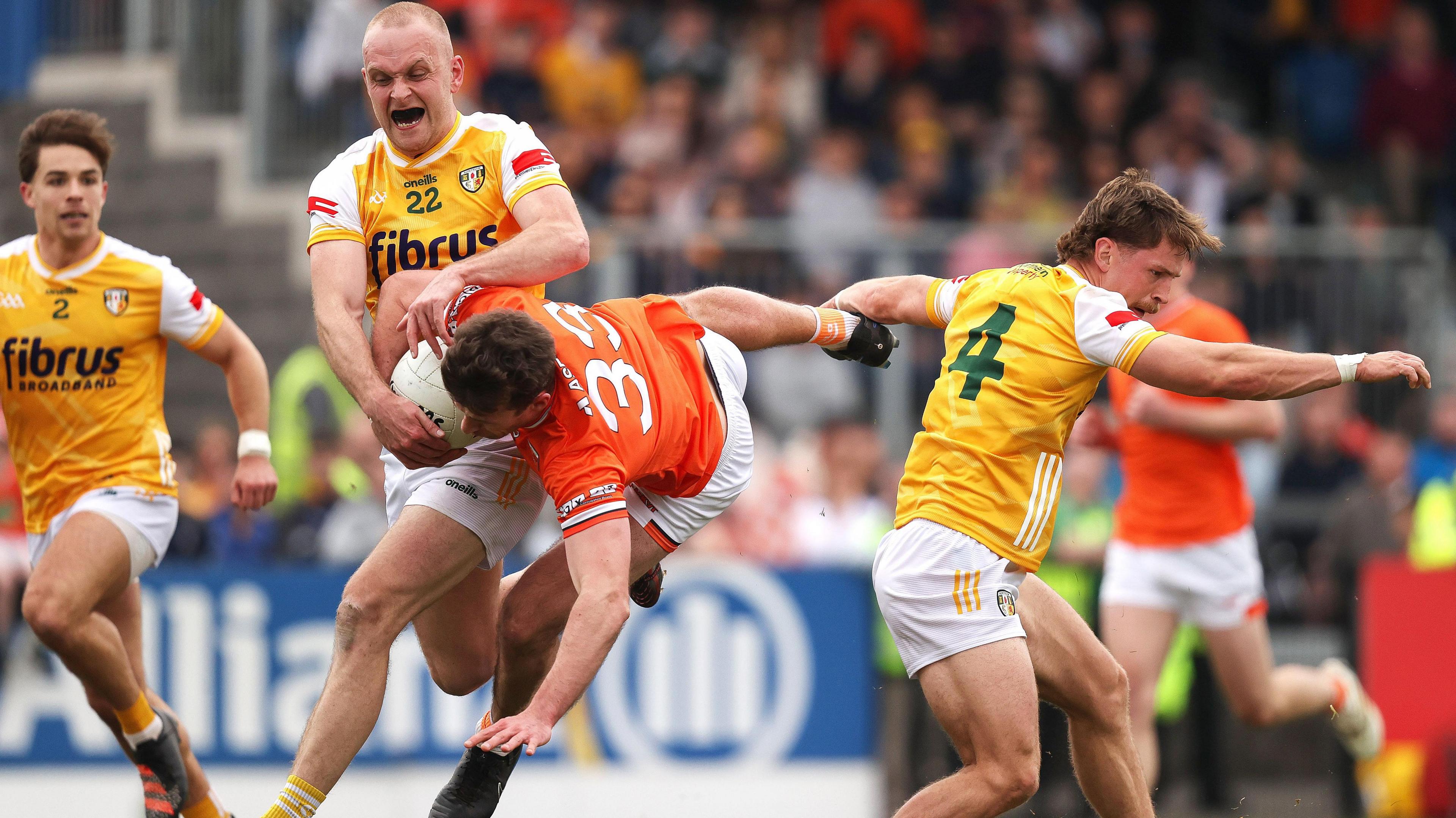 Ethan Rafferty takes a tumble after a challenge by Antrim's Kavan Keenan (right) during his stint outfield for Armagh following his return from a black card