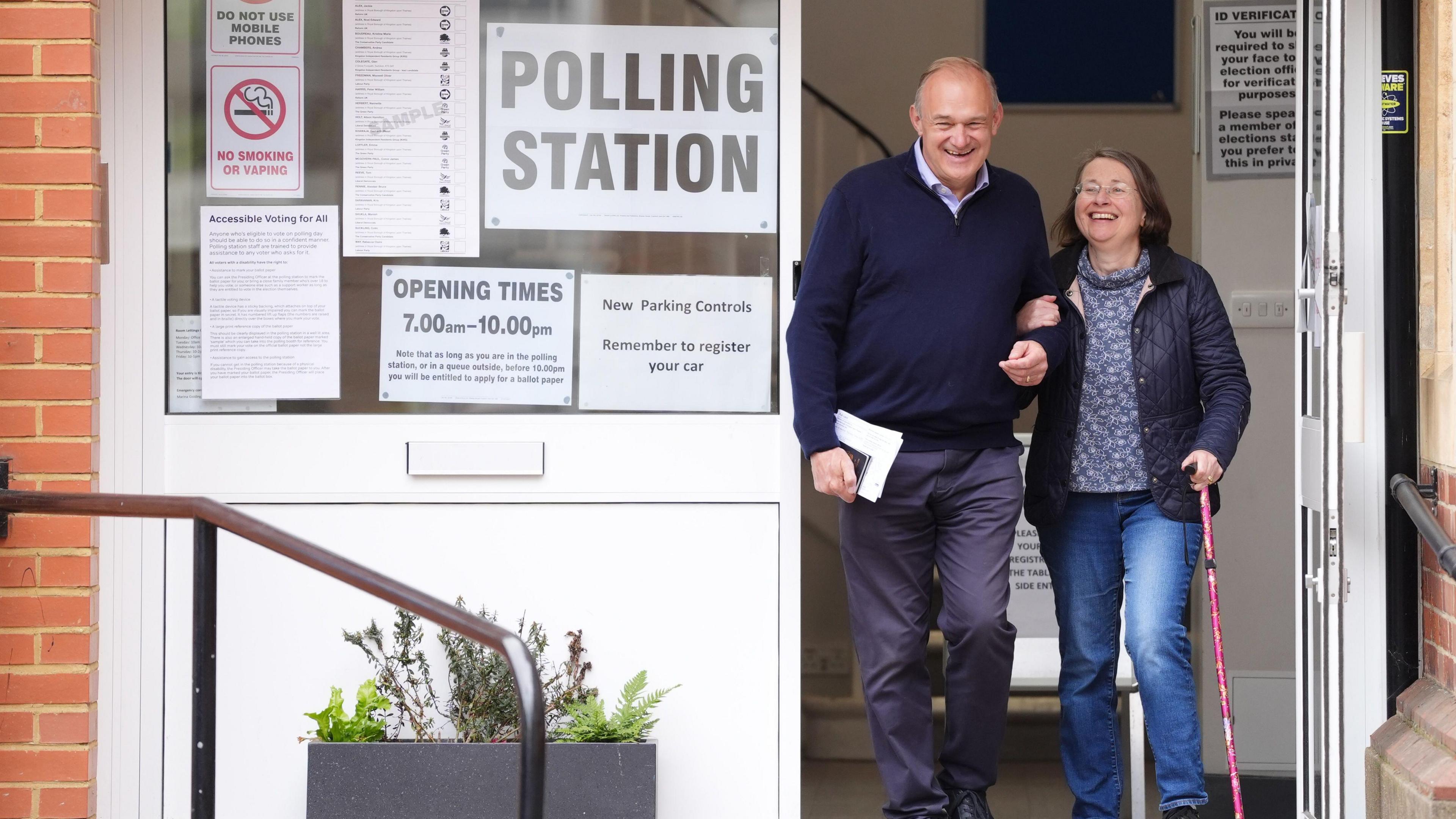 ed davi and his wife exiting a polling station and smiling