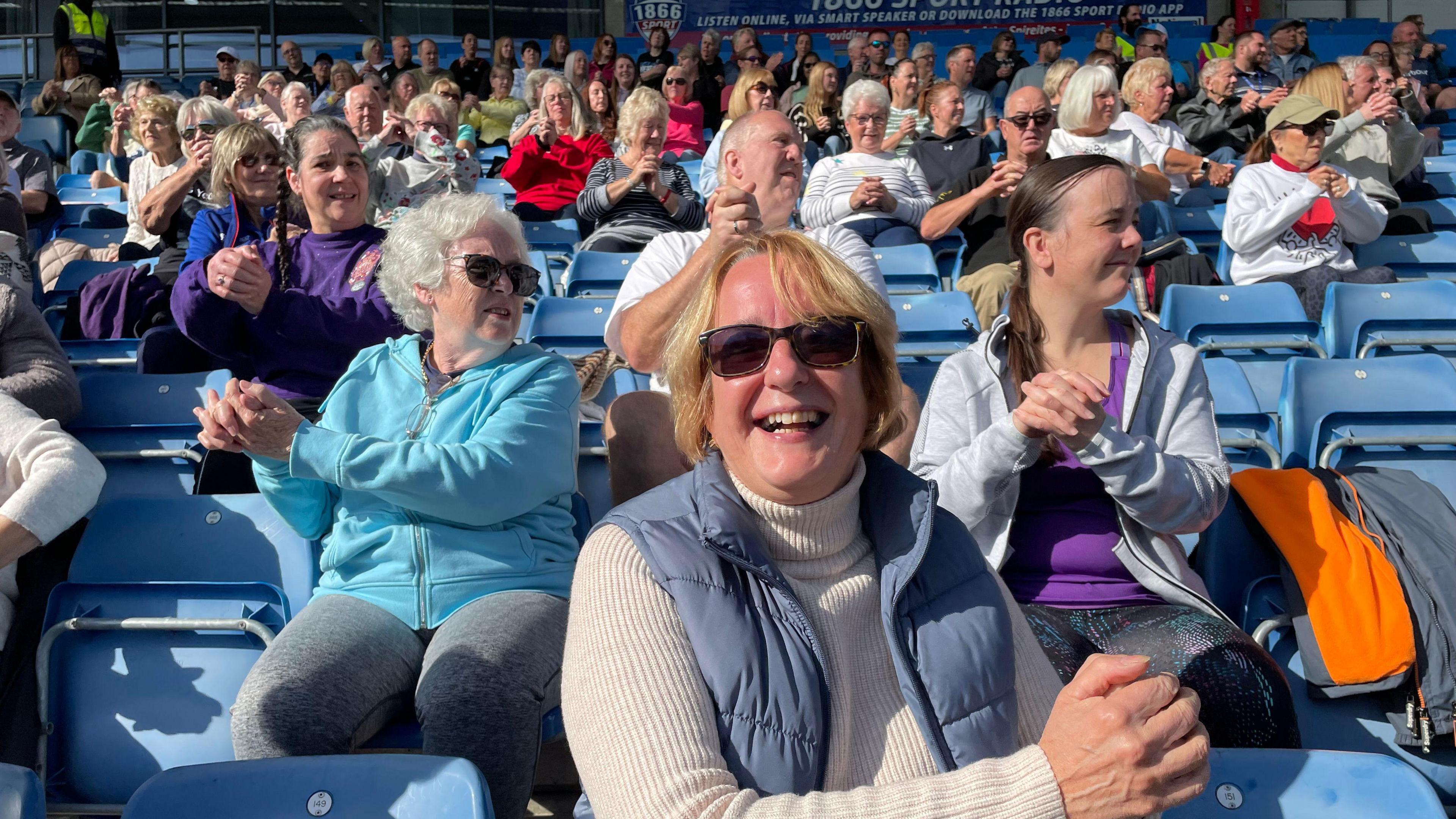 People at Chesterfield FC's ground exercising in their seats