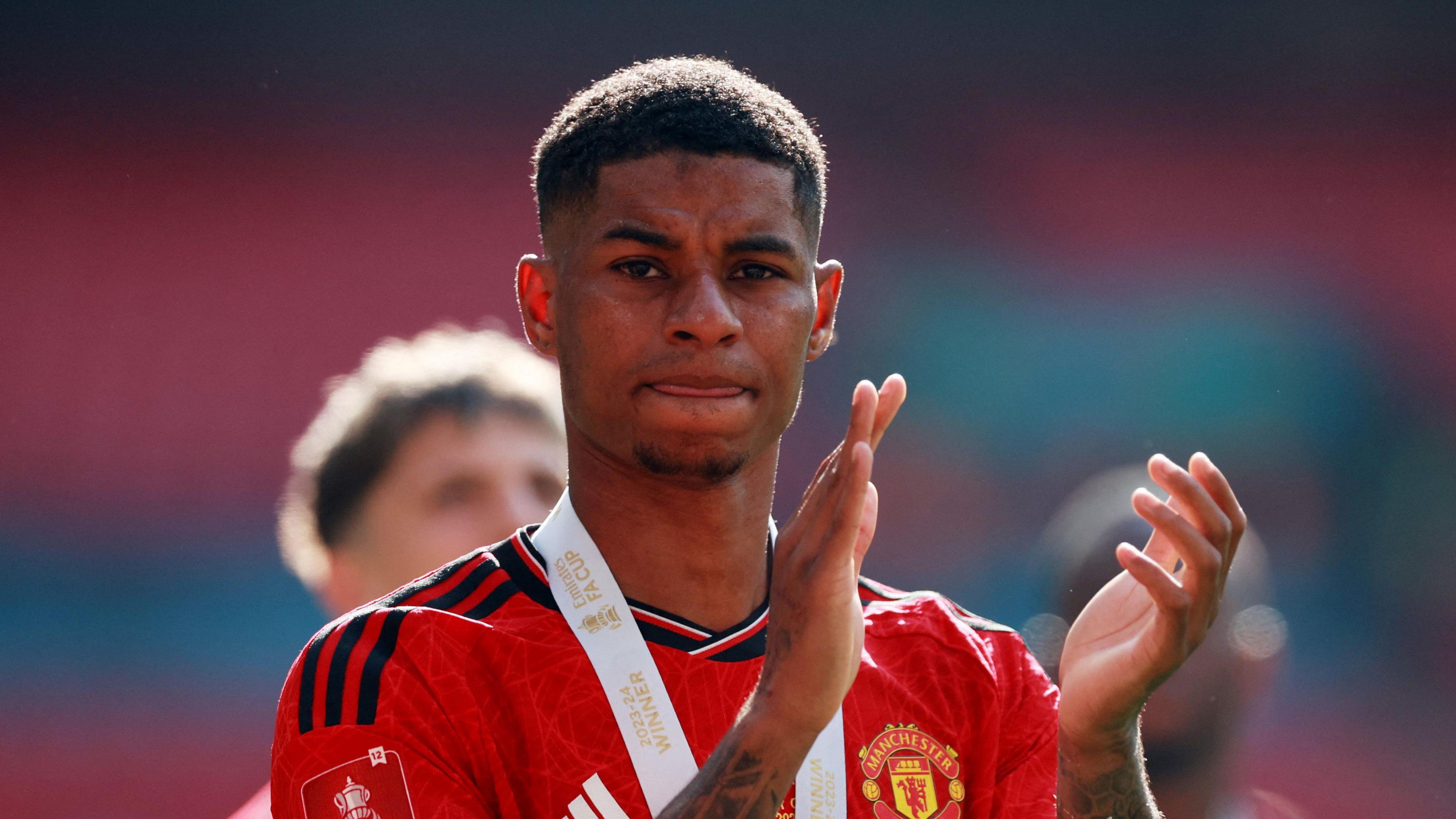 Marcus Rashford wearing his FA Cup medal in May