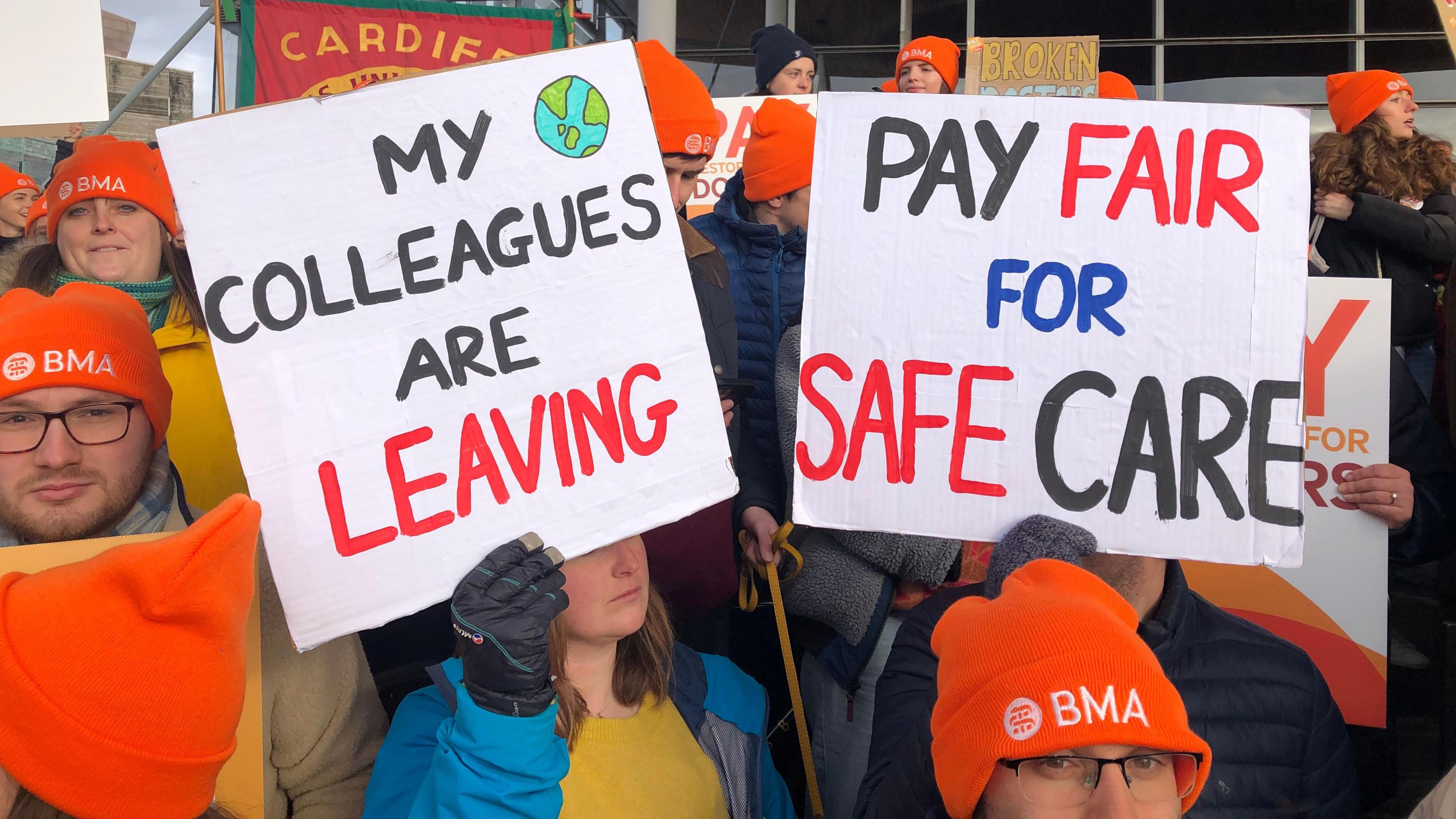 Junior doctors holding protest placards