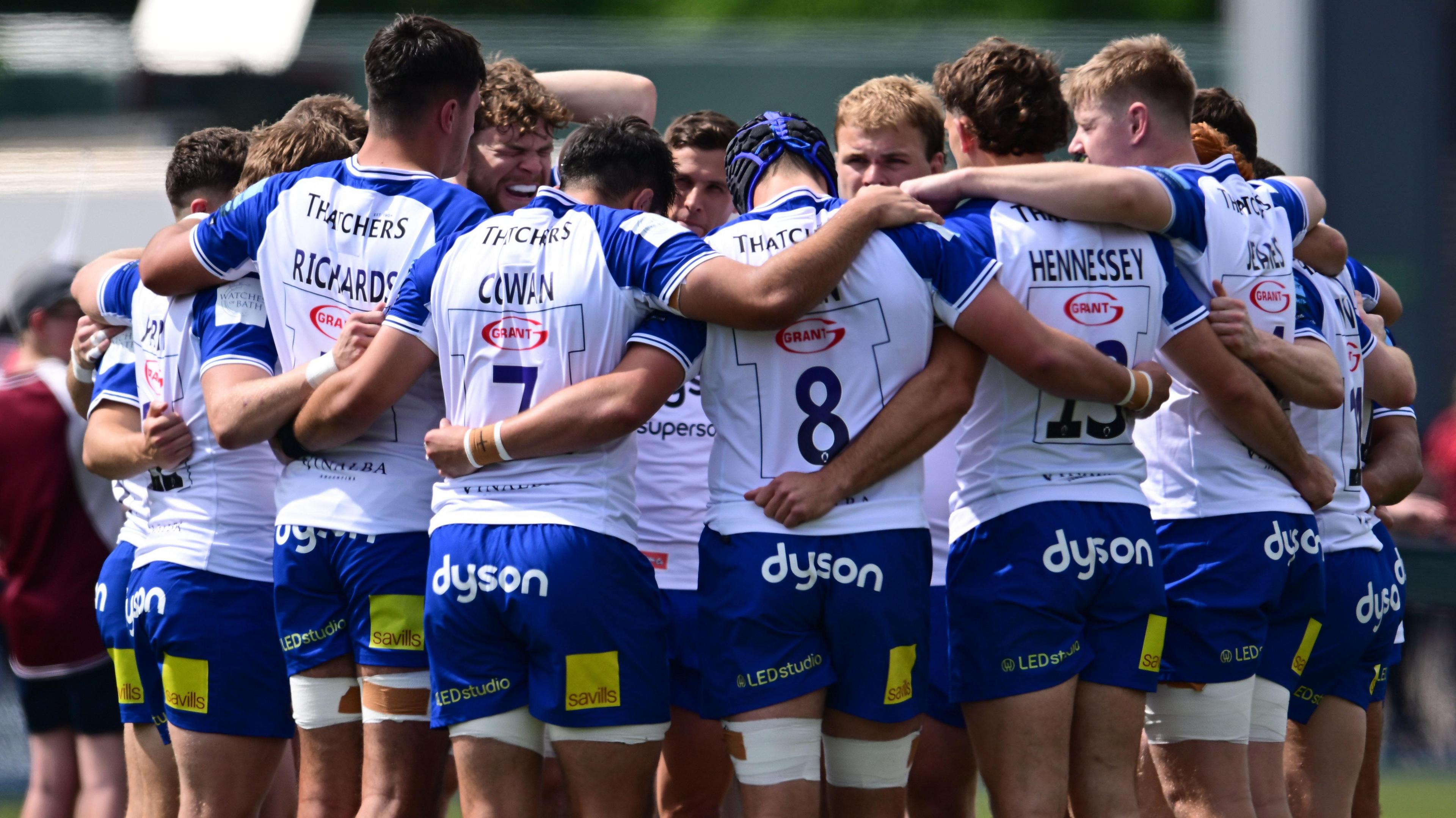 Bath players in a huddle during their match against Saracens