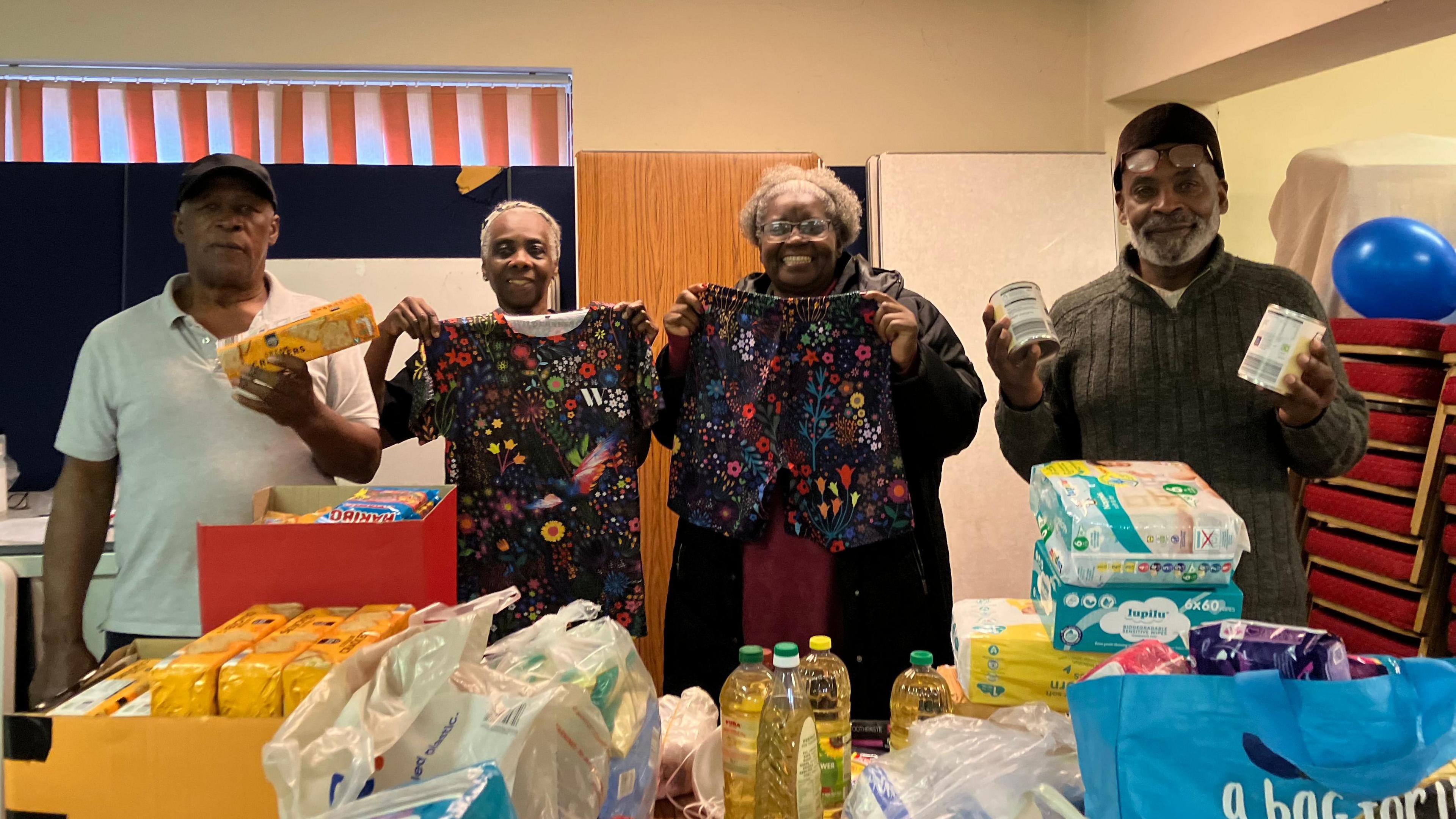 Afro-Caribbean National Artistic volunteers with supplies