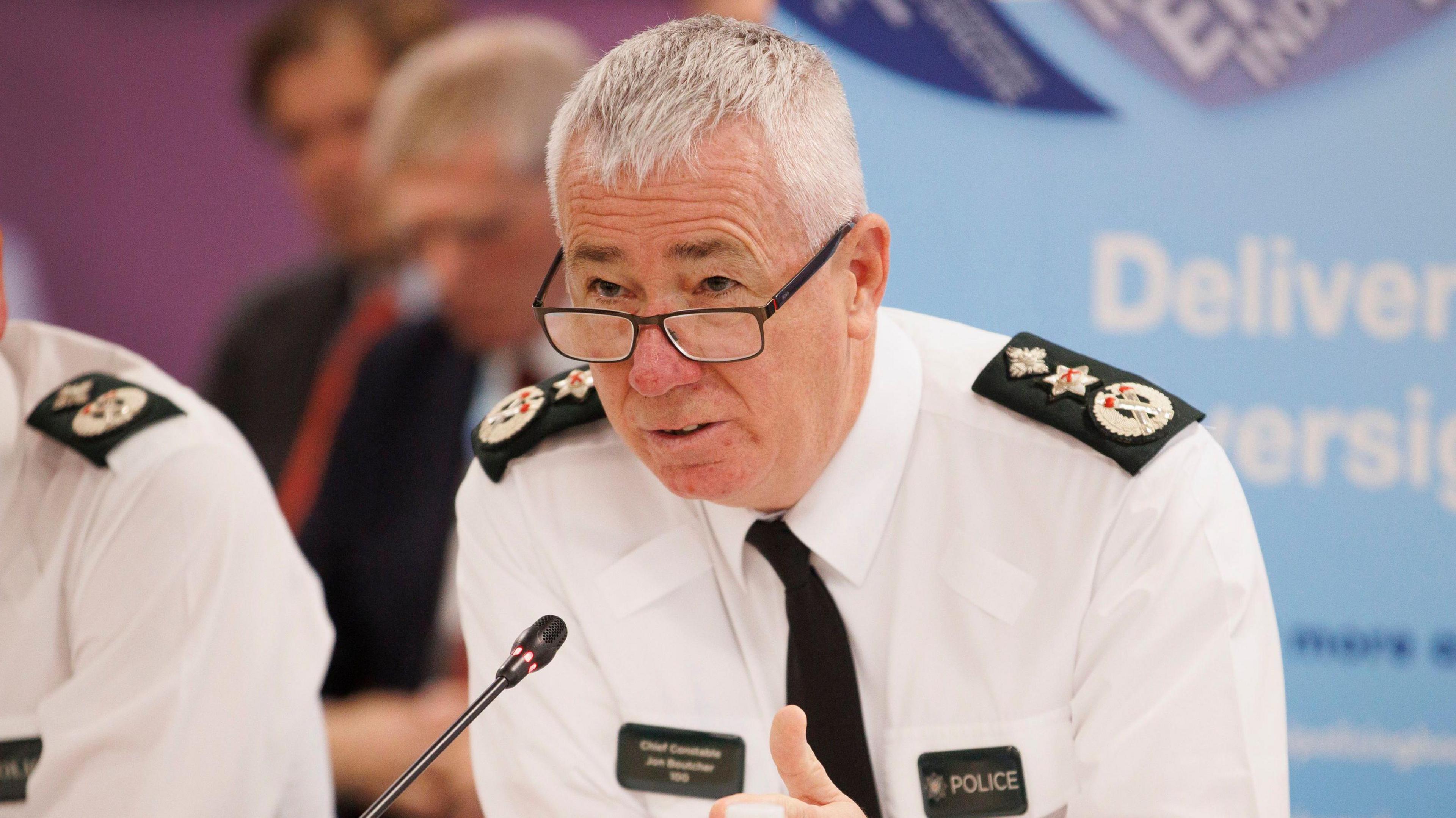 Jon Boutcher in police uniform. He wears glasses and has grey hair.