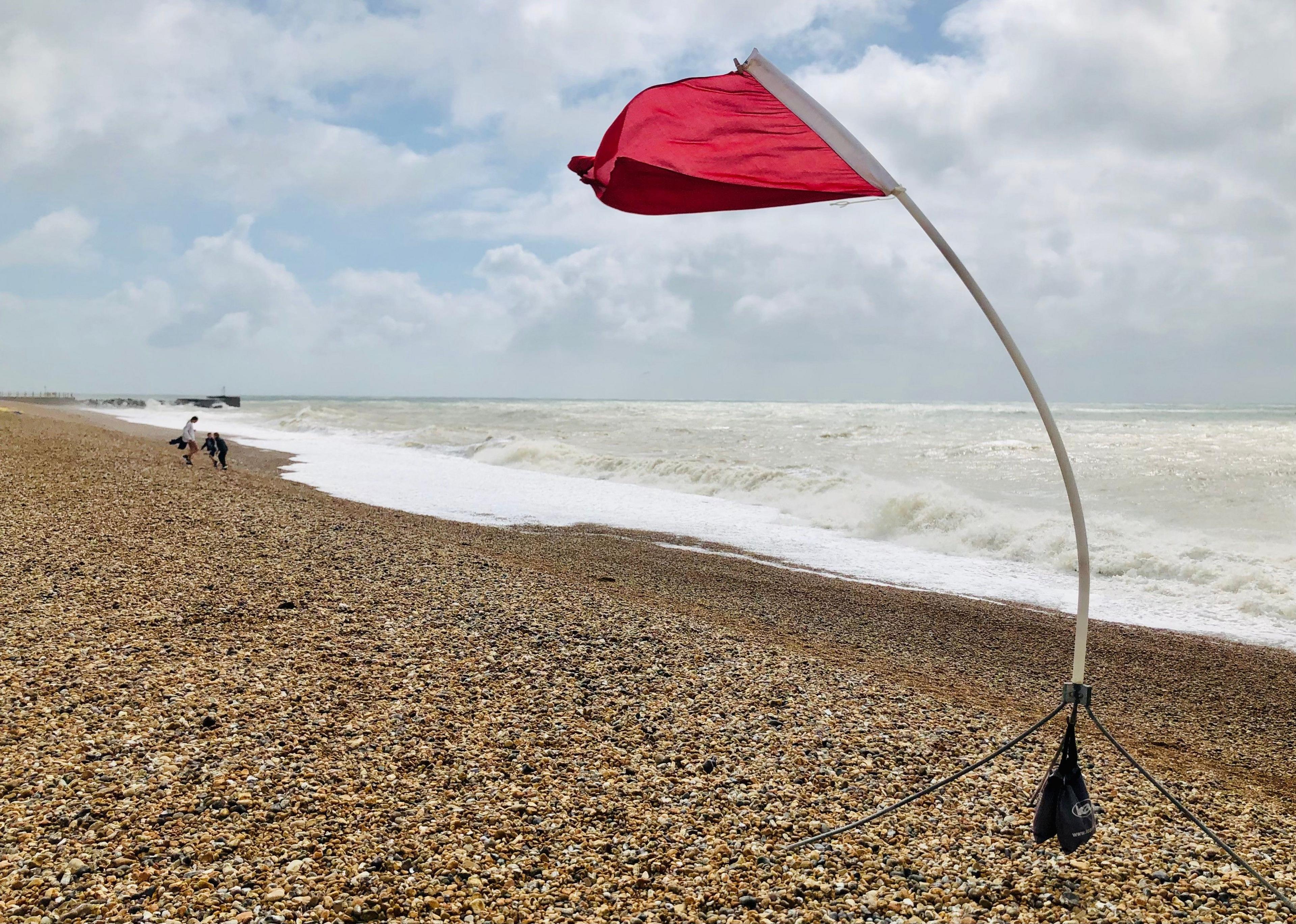 A red flag on a windy beach