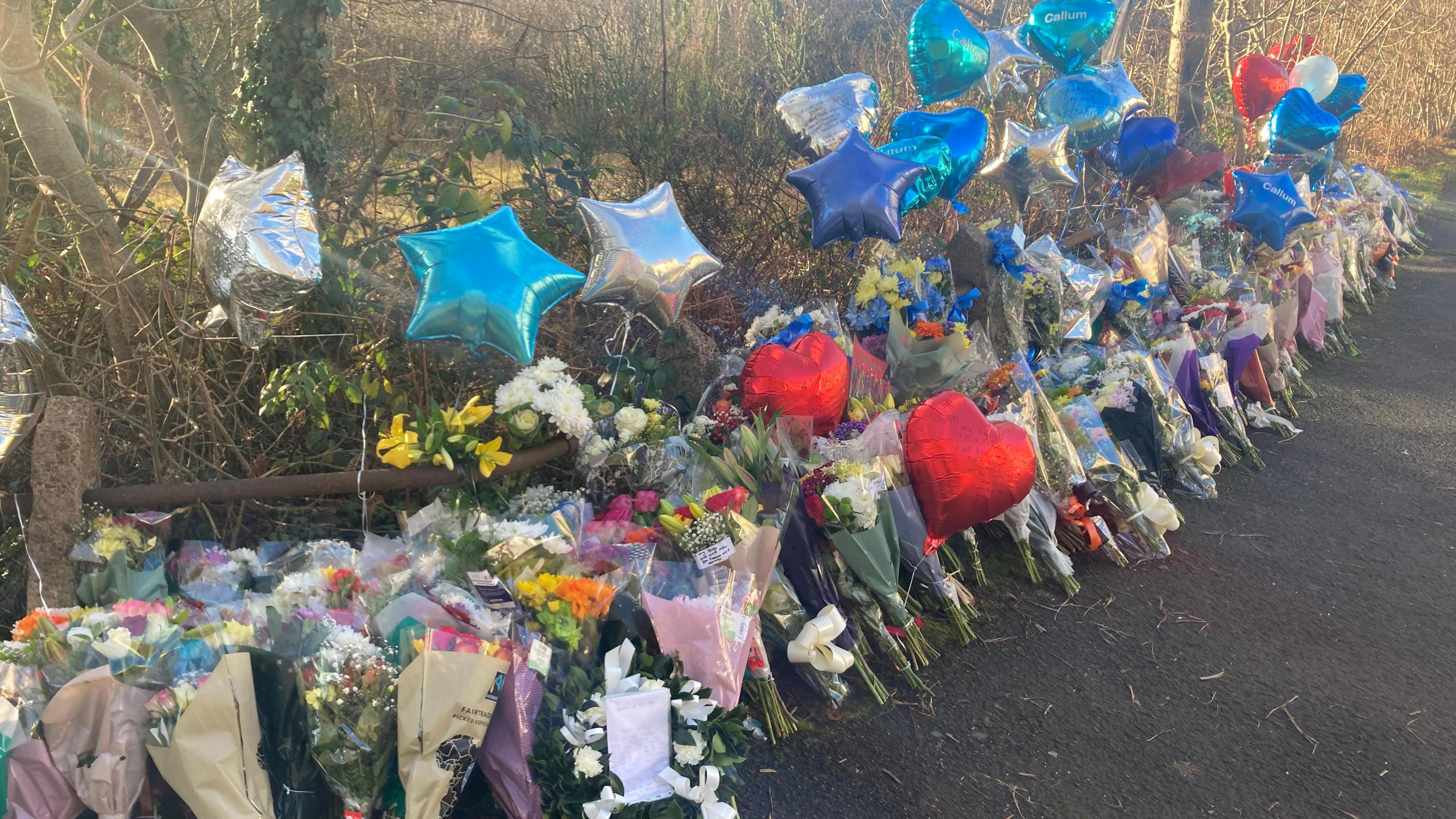 Flowers and balloons at the scene of the crash in Coedely, RCT in December 2023