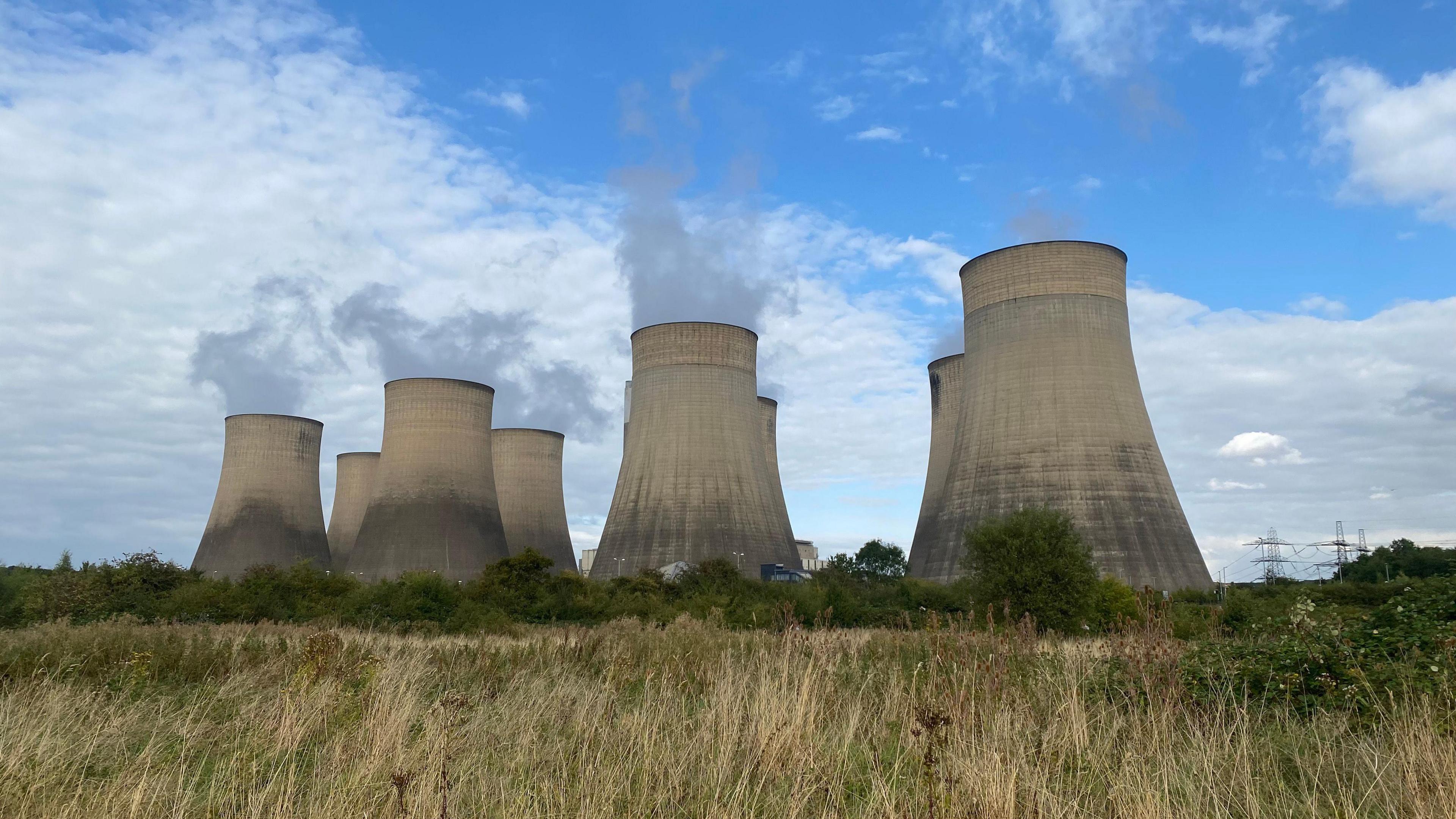 Ratcliffe-on-Soar's cooling towers seen through long fields of grass.