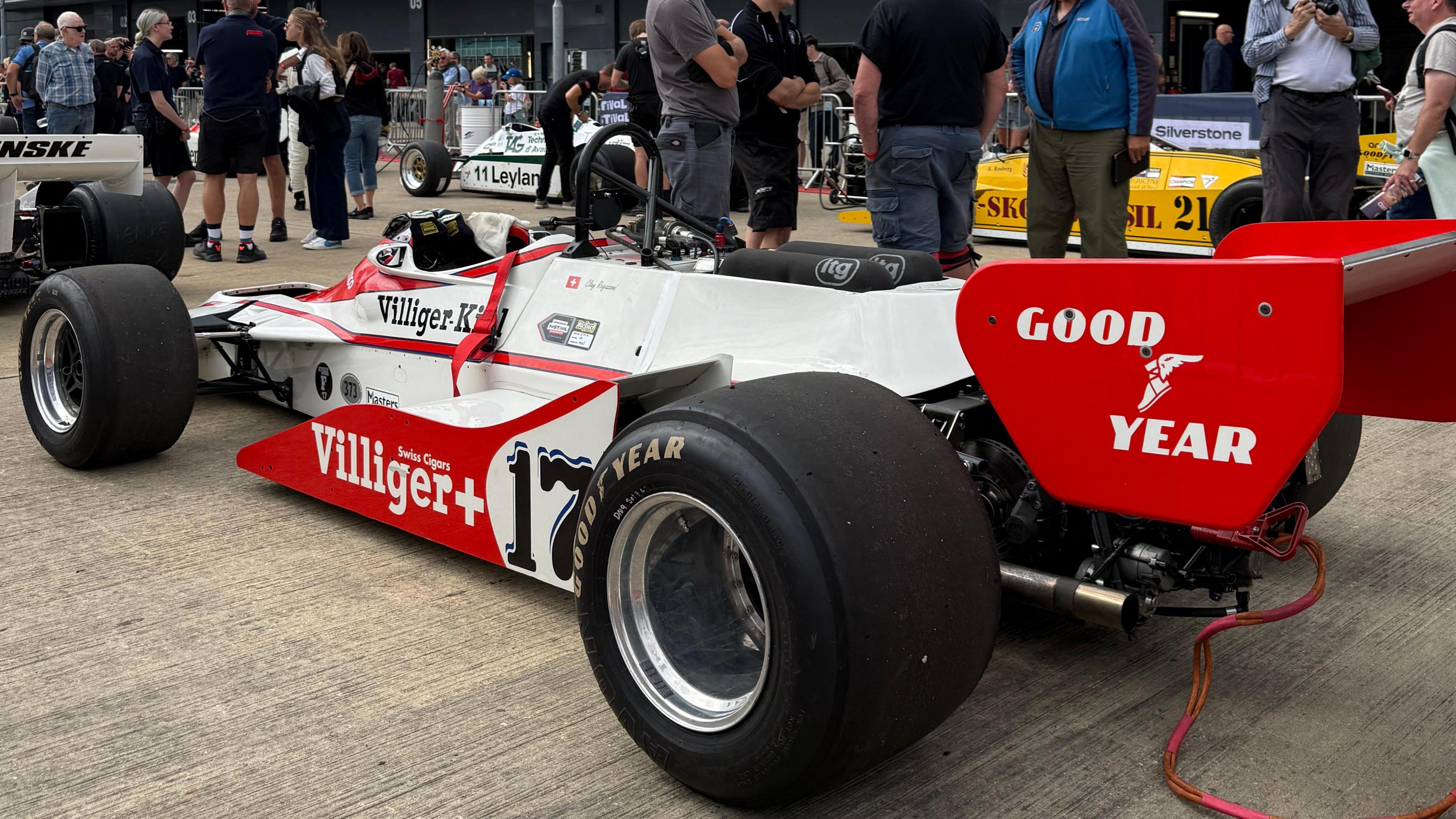 A white and red car with 'Good Year' written in white and 'Swiss Cigars Villiger+' on the side of the car.