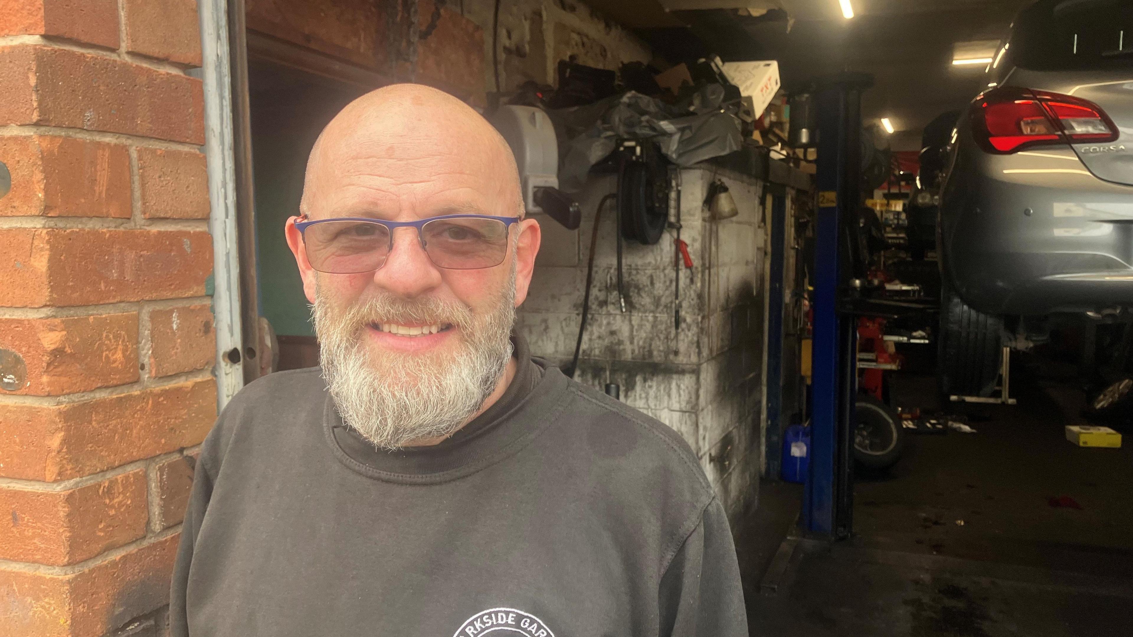 Mark Jones in front of his garage