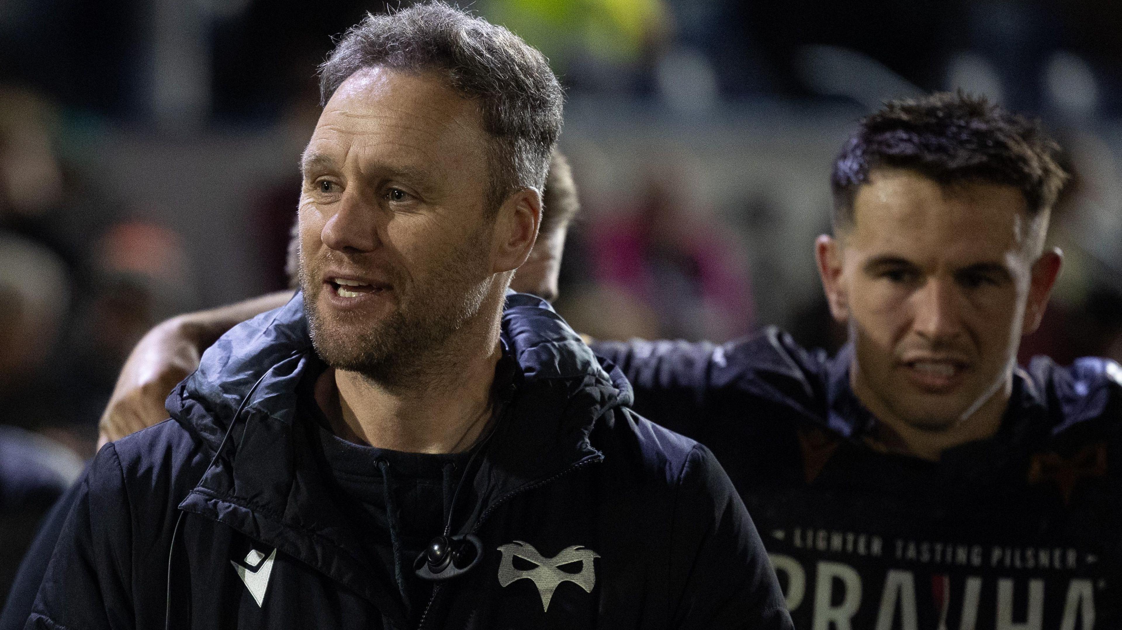 Ospreys head coach Mark Jones talks to his players