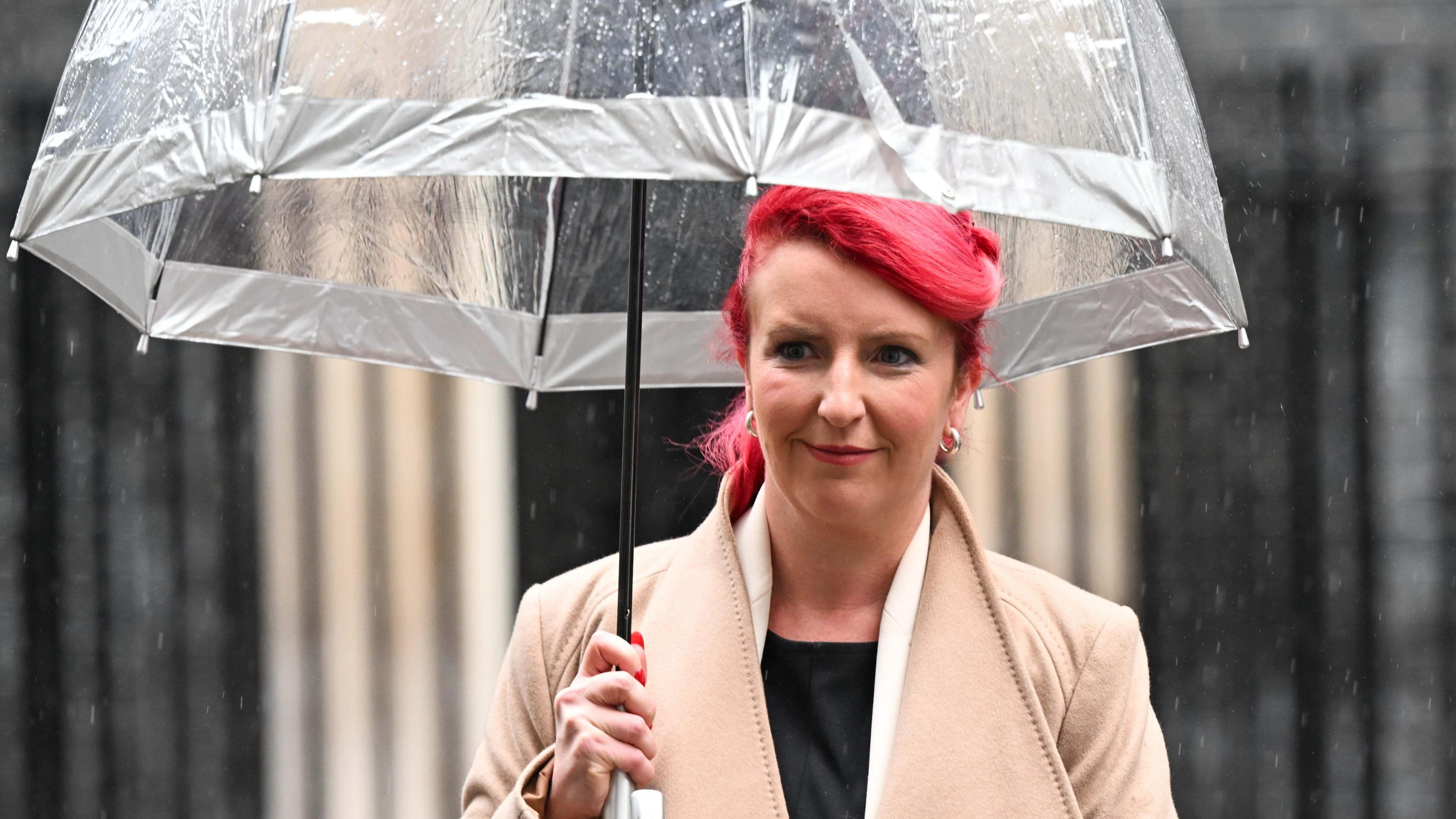 Louise Haigh, pictured in Downing Street holding an umbrella and sporting high-dyed hair