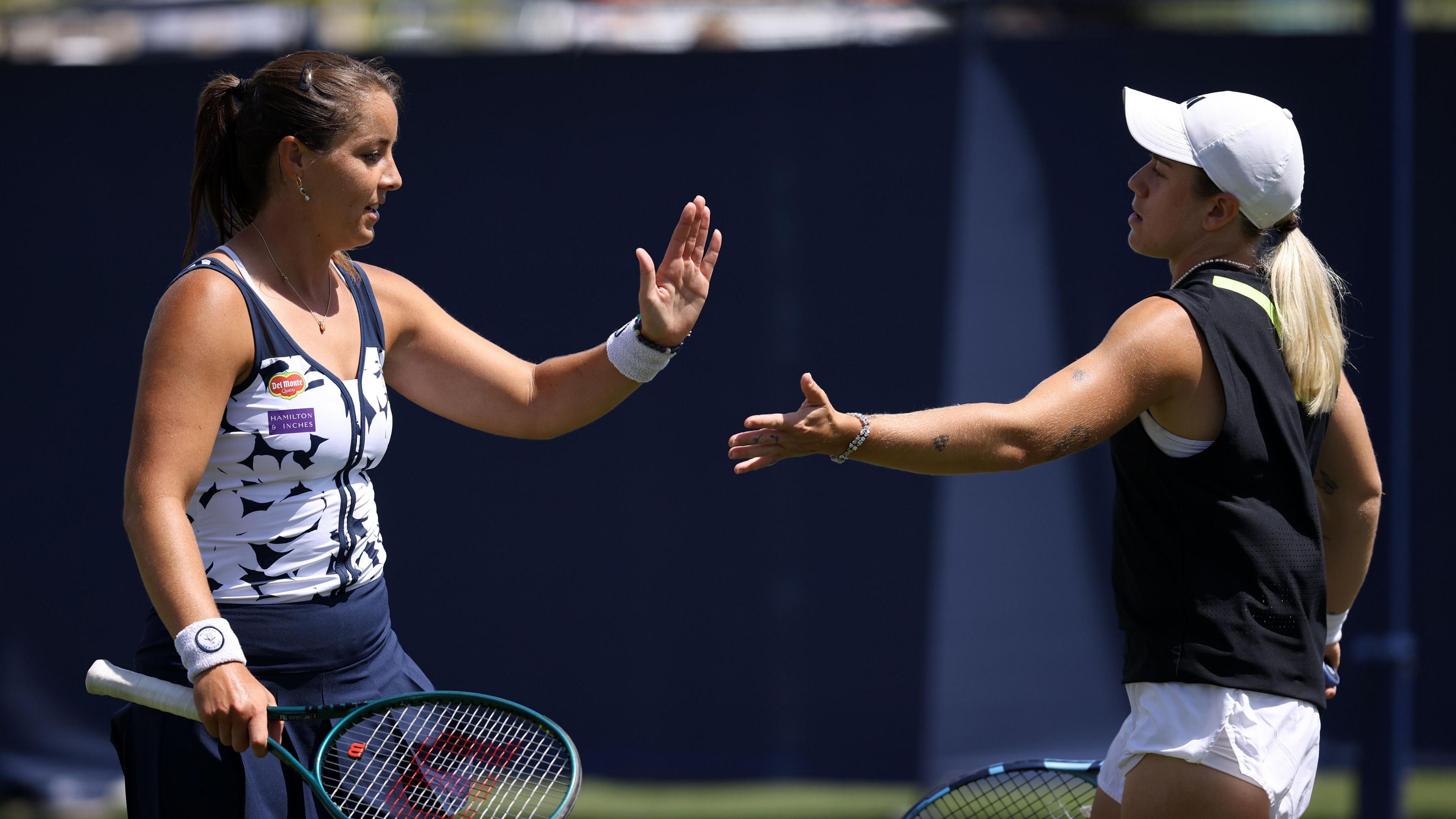 Jodie Burrage of Great Britain and Sonay Kartal of Great Britain interact on the tennis court.