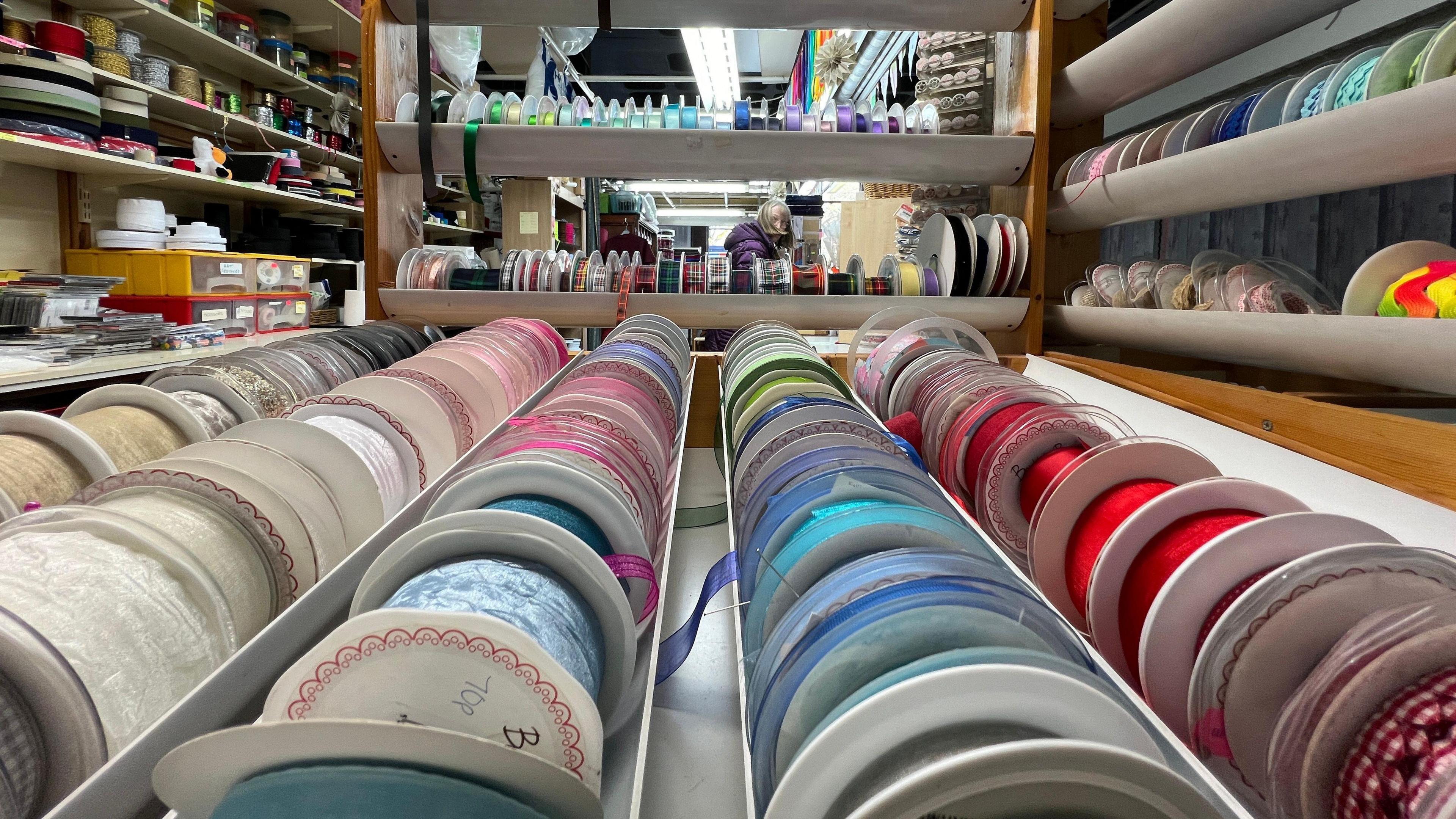 Ribbons and threads on display at a market stall