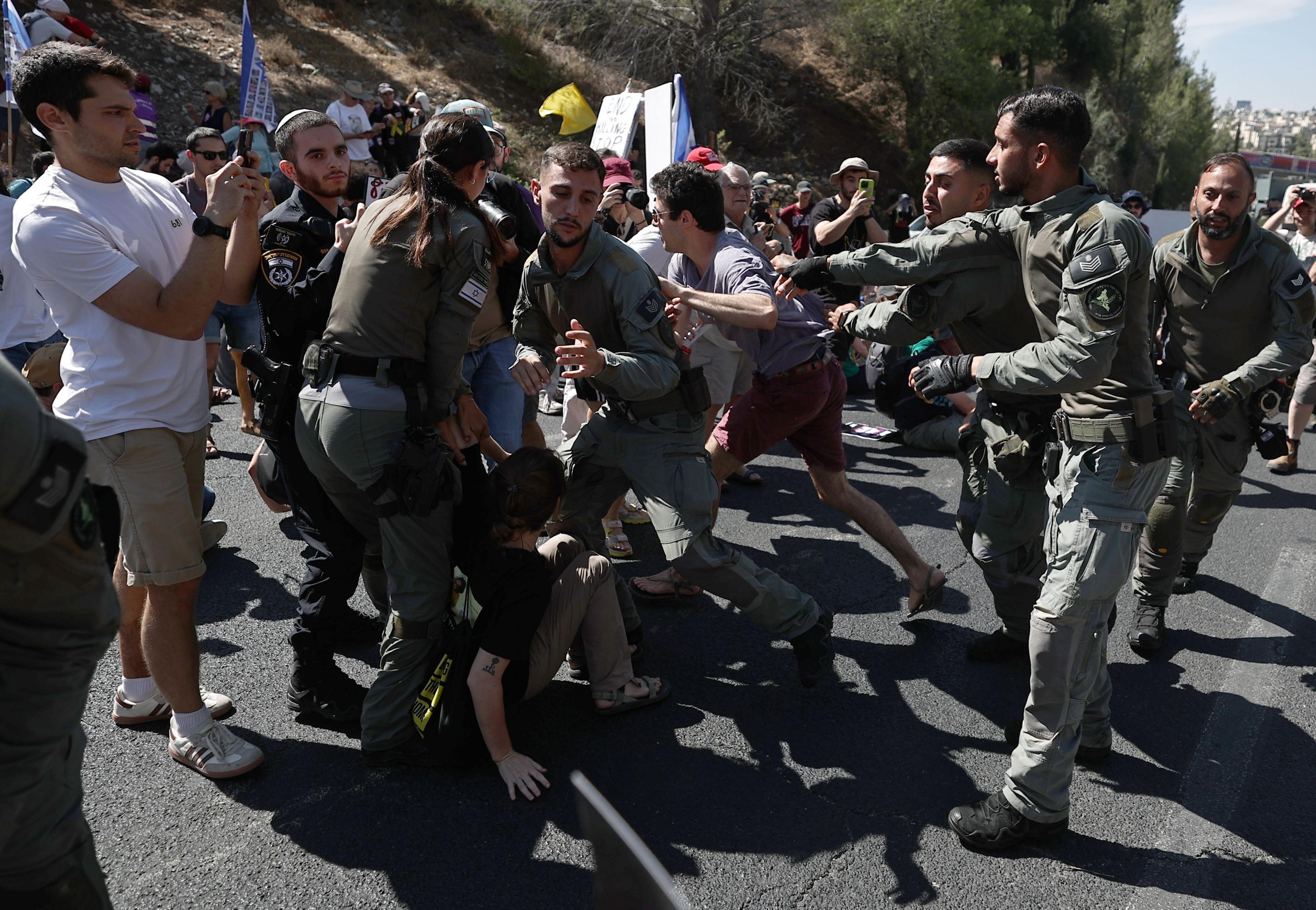 Israeli protesters are dragged away while blocking a major highway amid nationwide strike in Jerusalem on 17 August 2025.