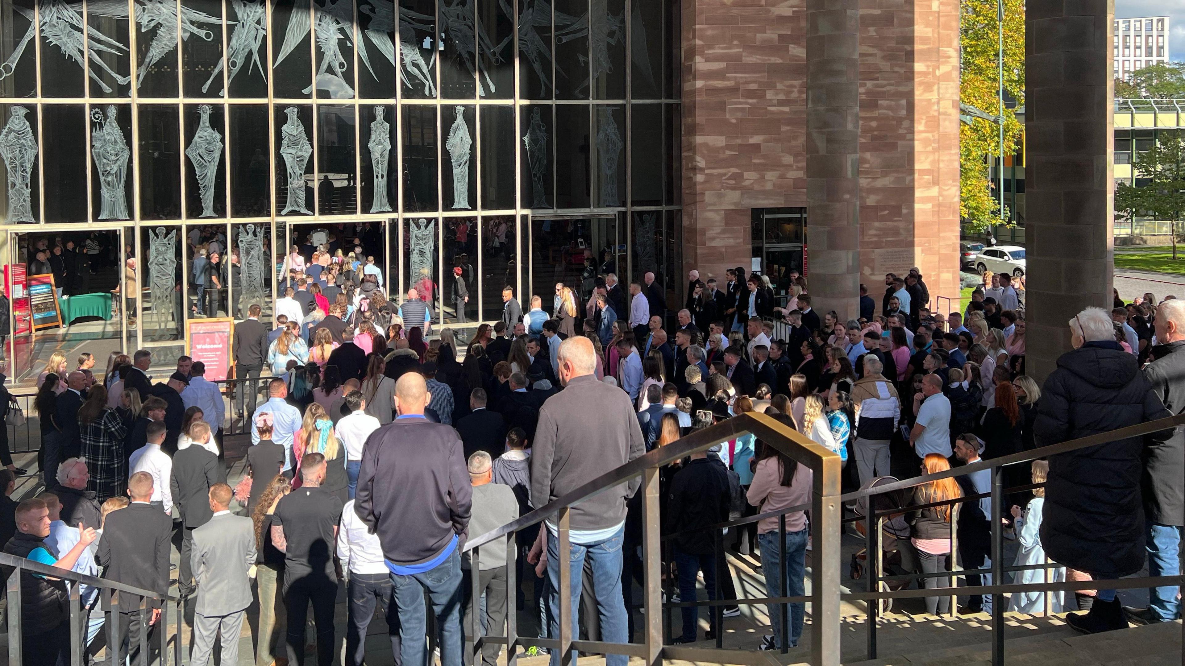 Hundreds of people waiting to enter Coventry Cathedral for the funeral of Kane Forder