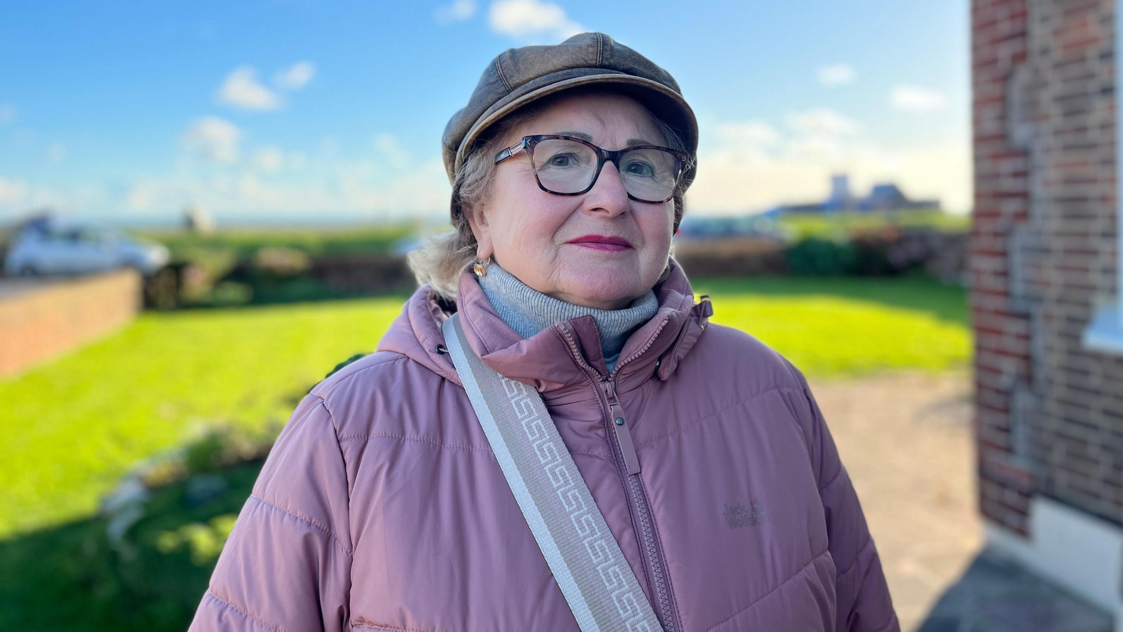 Svetlana Westgate wearing a purple anorak, grey had and grey polar neck sweater.