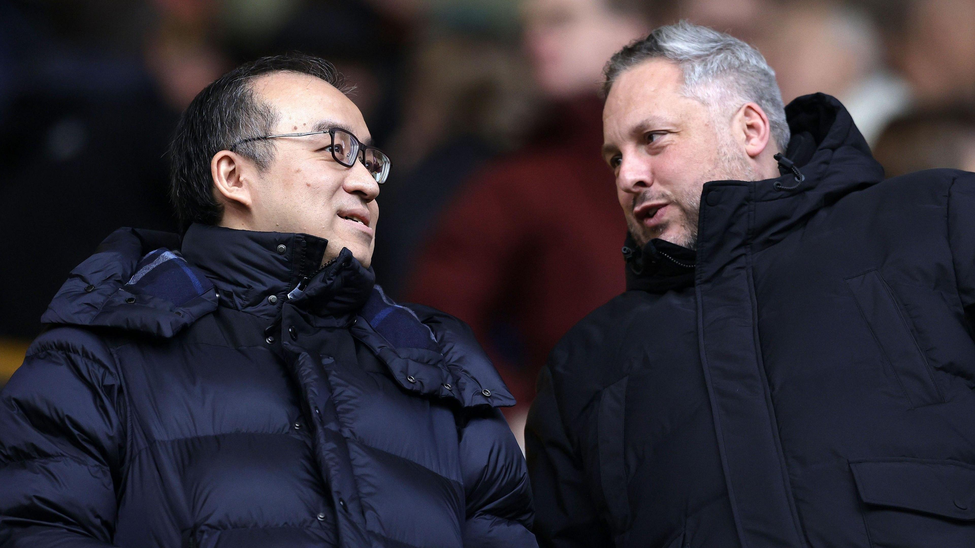 Wolves chairman Jeff Shi and sporting director Matt Hobbs talk in the stands at Molineux.