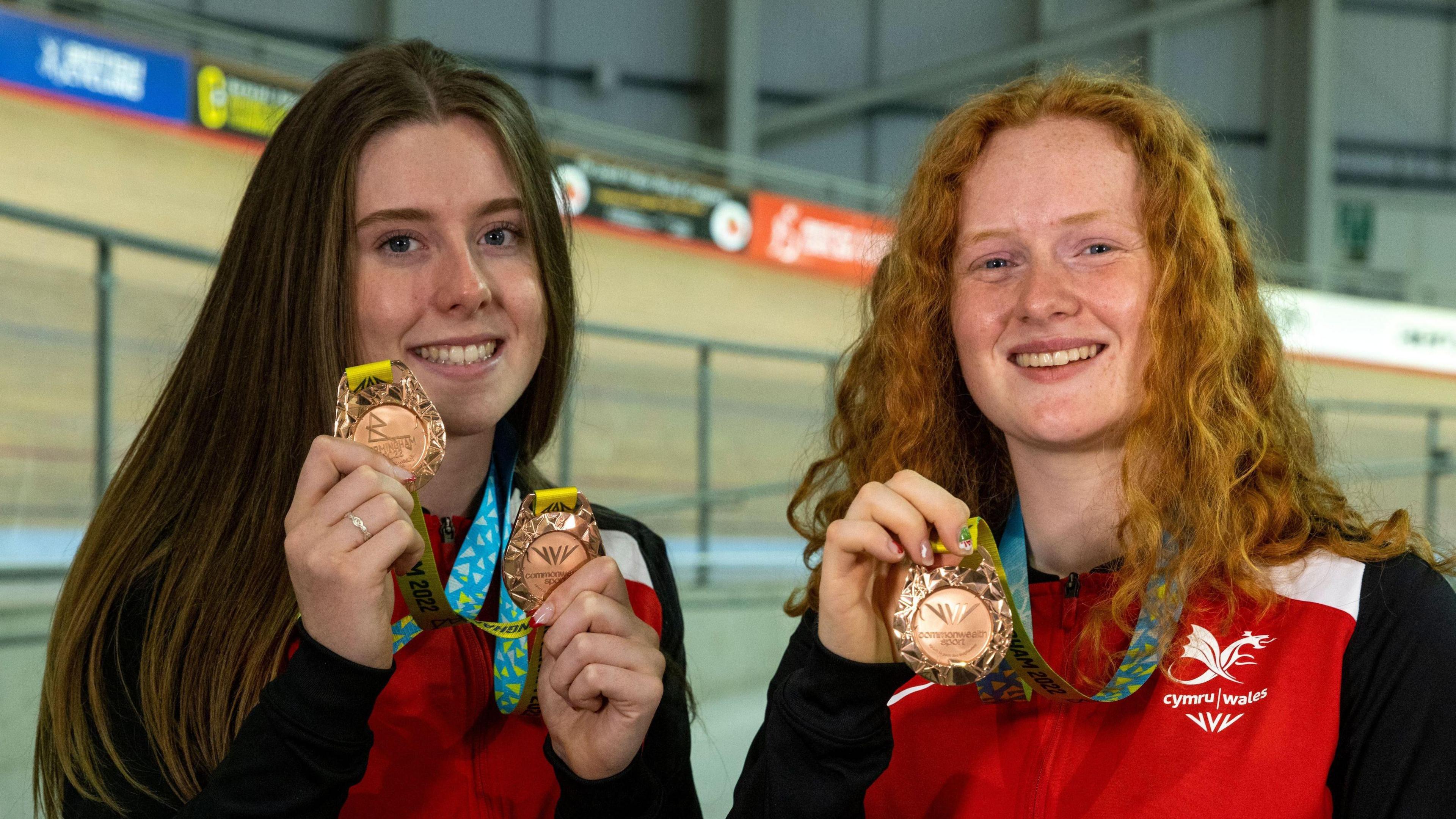 Rhian Edmunds and Emma Finucane pose for a photograph as Colin Jackson and Dani Rowe visit The National Lottery funded Newport Velodrome as part of the Commonwealth Games on August 04, 2022 in Newport, Wales. 