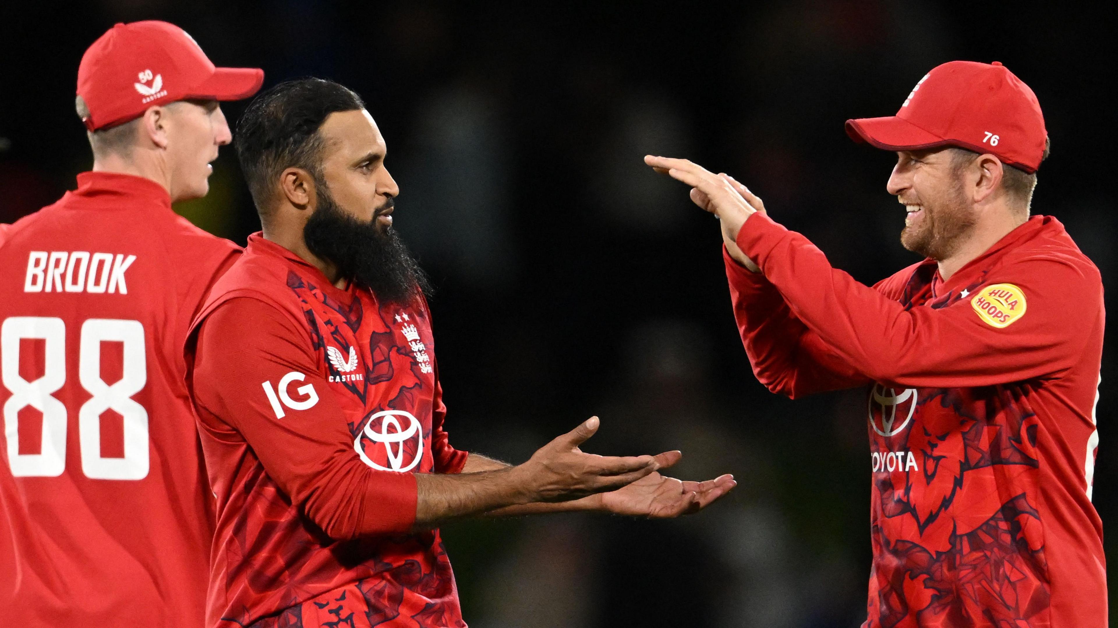 England spinners Adil Rashid (centre) and Liam Dawson (right) celebrate a wicket