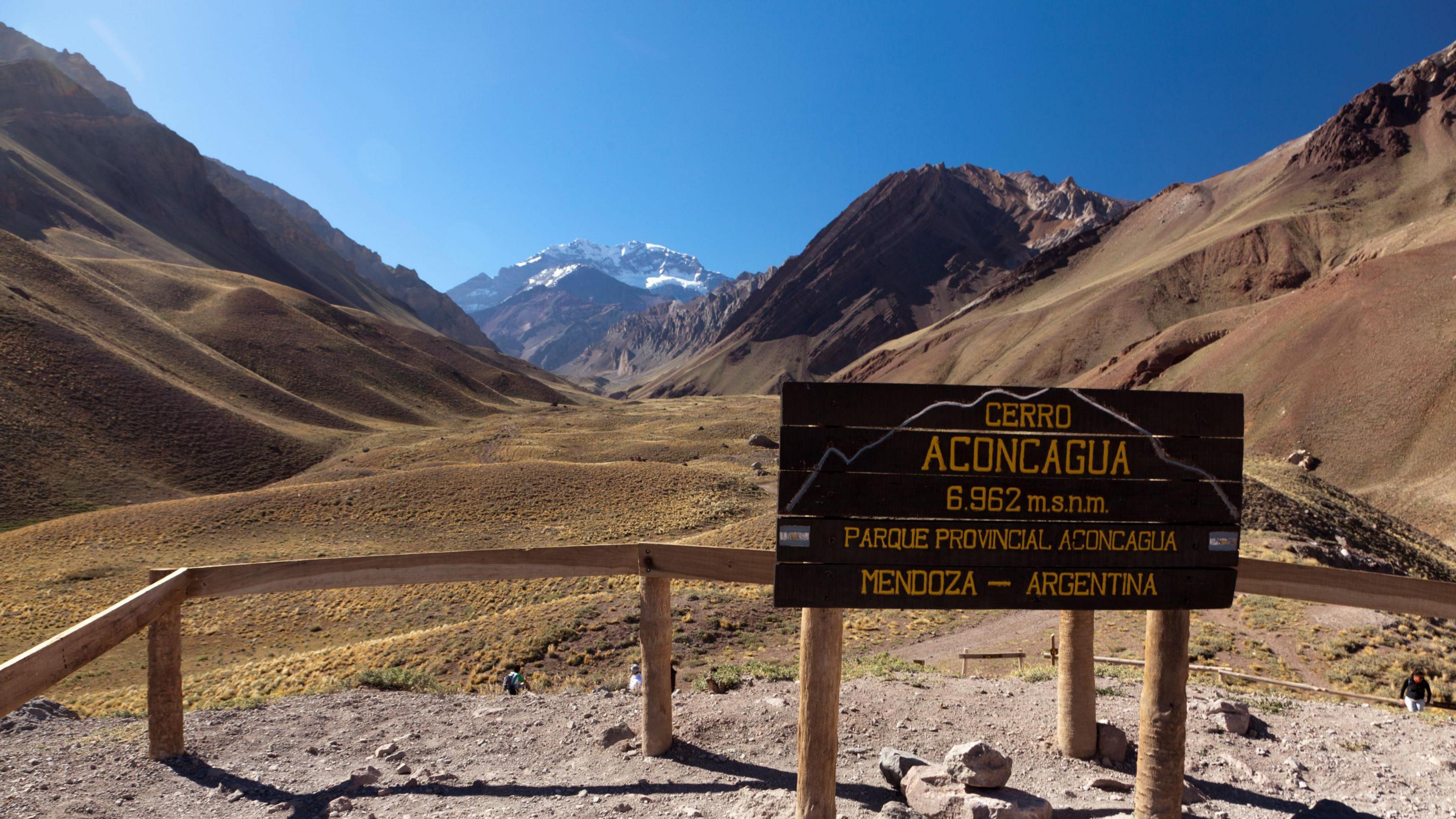 A sign for Aconcagua with the mountain in the background