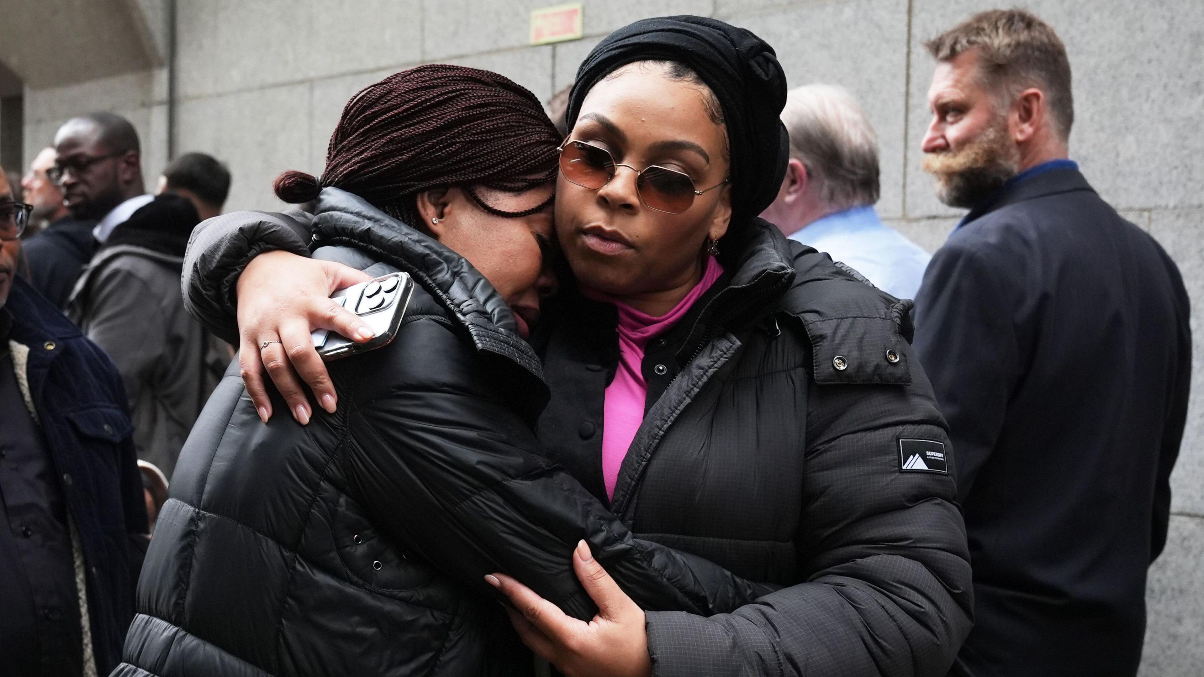 Helen Lumuanganu (left), the mother of Chris Kaba, arriving at the Old Bailey being comforted by member of the Justice For Chris Kaba group.