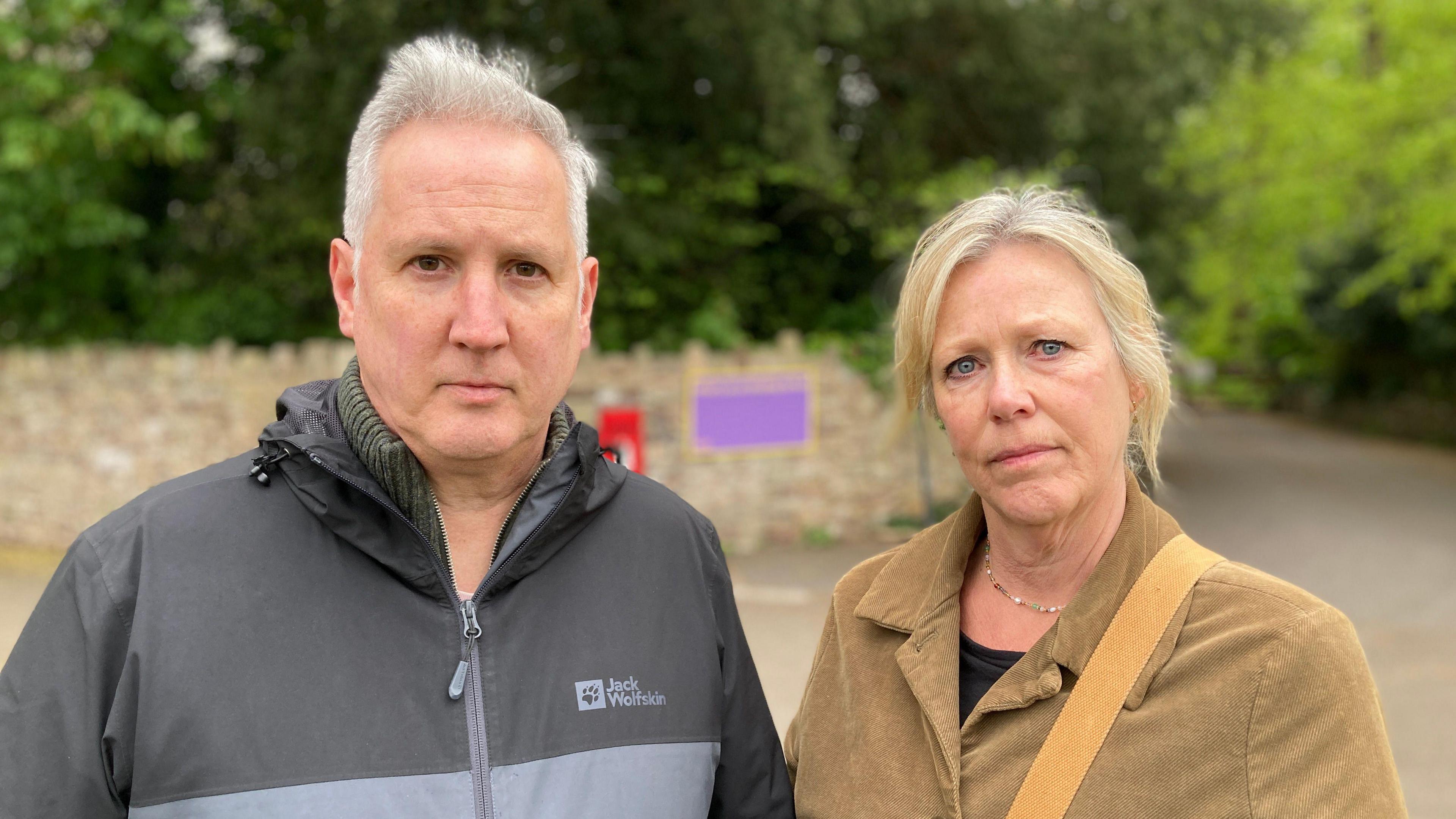 Image of Graham and Zoe standing outside looking at the camera